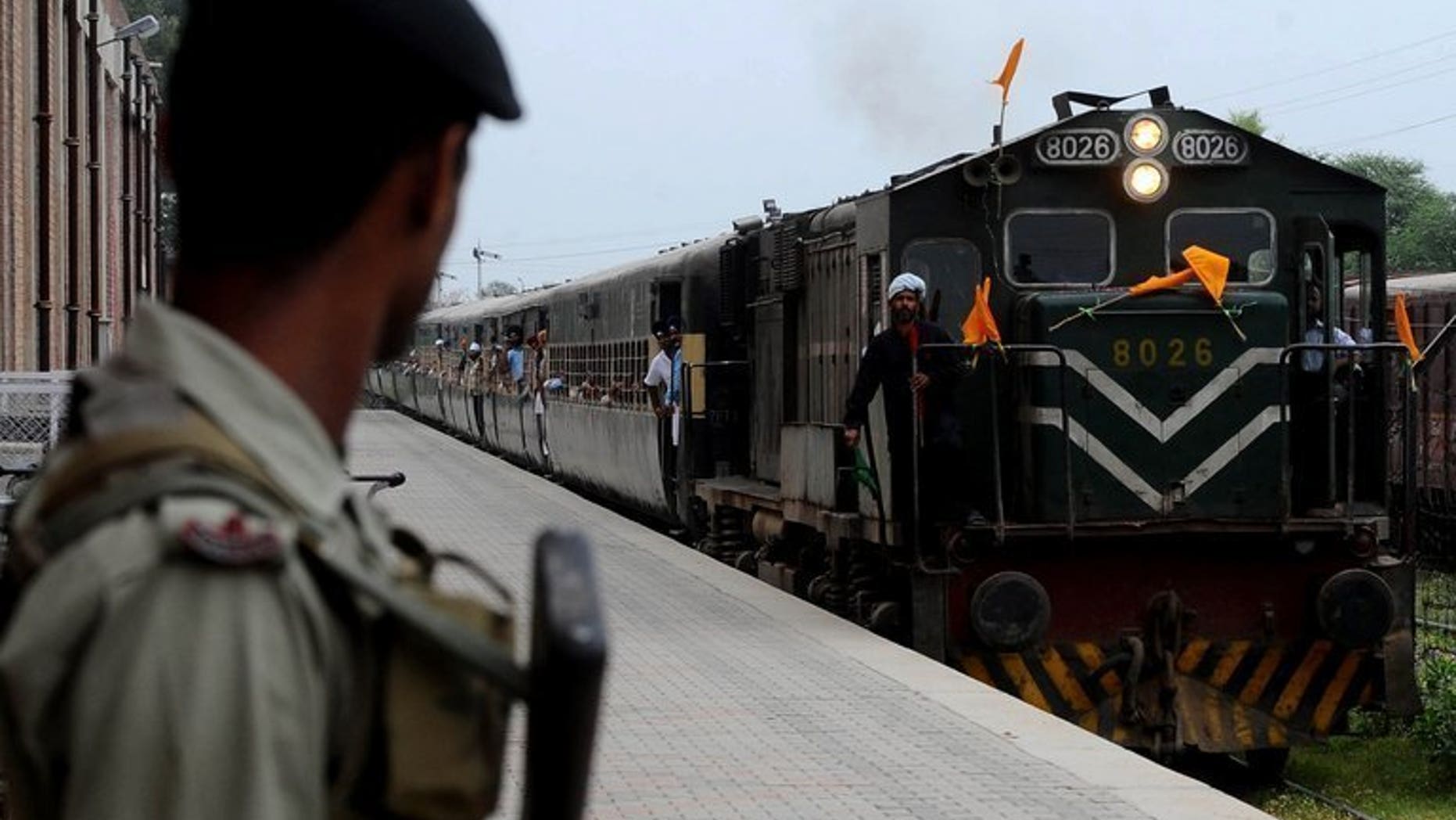 A Pakistani paramilitary soldier watches a train arriving at Wagah railway station in Wagah, northeast Pakistan on April 10, 2012. A bomb exploded on a passenger train in central Pakistan Monday, killing a toddler and wounding 13 others, officials said, in what the railways minister called "an act of terrorism".