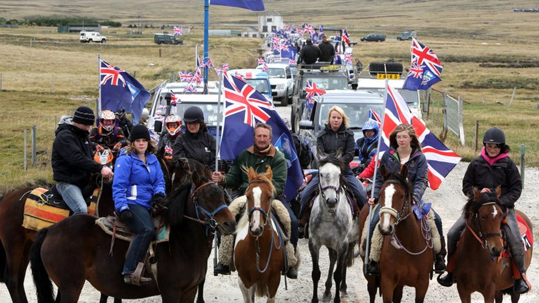 Islanders take part in the "Proud to be British" parade along Ross Road in Port Stanley, Falkland (Malvinas for Argentina) Islands, on March 10, 2013. Sandy Woodward, who commanded the British navy task force that retook the Falkland Islands in the 1982 war with Argentina, has died aged 81, the defence ministry confirmed.