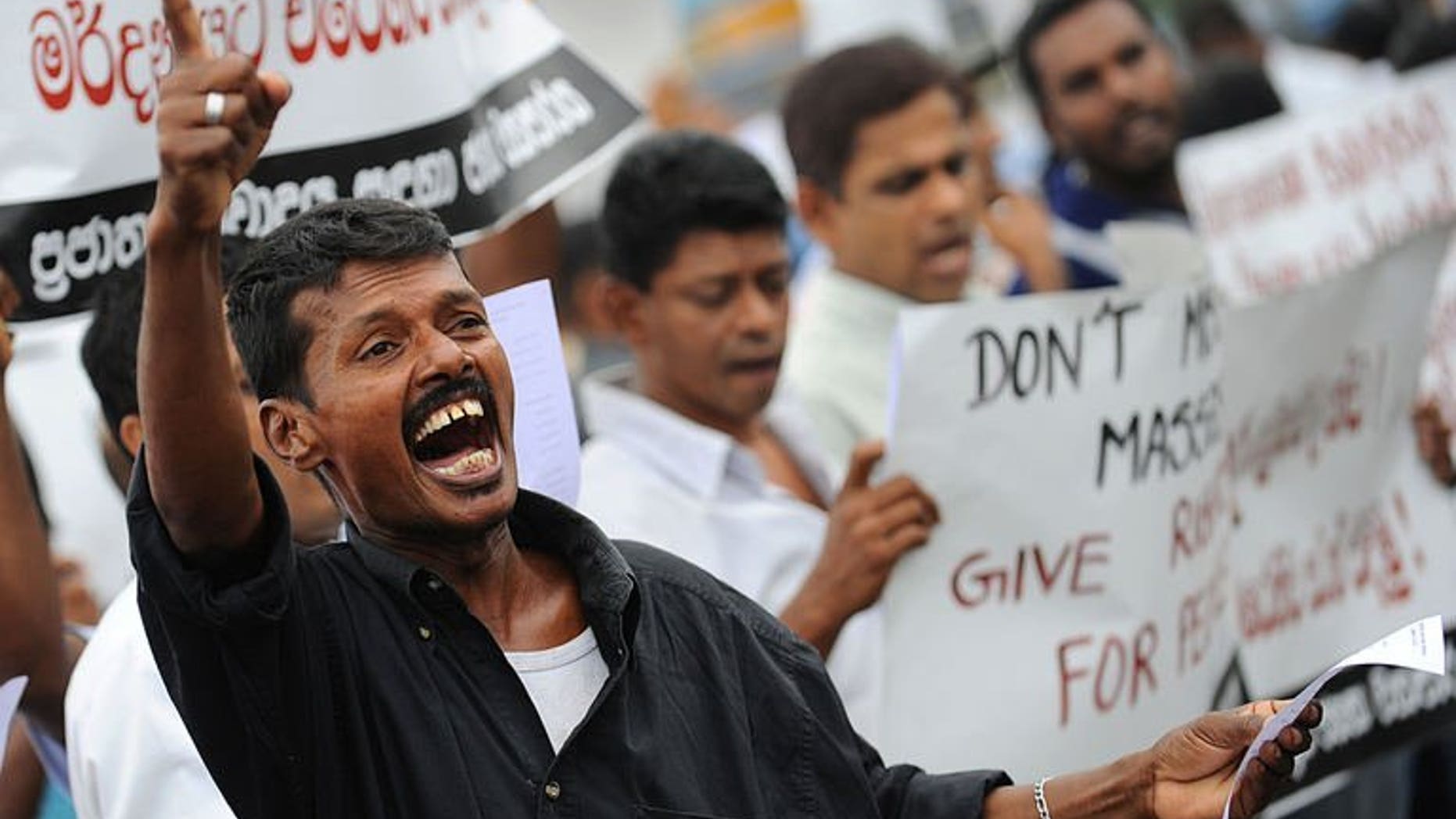 A supporter of Sri Lanka's Marxist JVP or People's Liberation Front demonstrates in the capital Colombo on August 5, 2013 to denounce a deadly army crackdown on villagers who were protesting against contaminated water supplies. Several hundred anti-government supporters staged the rare protest Monday.