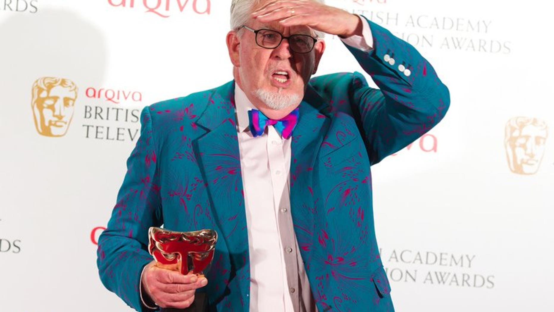 Winner of the Bafta Fellowship award, Australian entertainer Rolf Harris poses in front of the winners boards at the British Academy Television Awards at the Royal Festival Hall in London, on May 27, 2012. Harris was re-arrested by police in Britain on Monday over further allegations of sexual offences.
