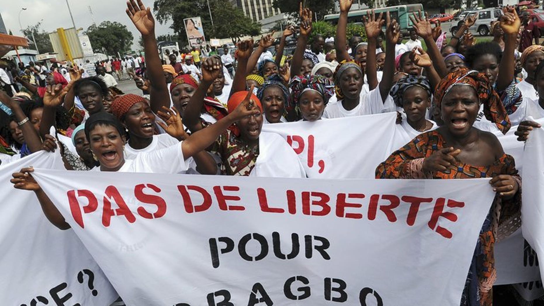 Women hold a banner reading "No Freedom for Gbagbo" during a demonstration for victims of the 2011 crisis in Ivory Coast, on June 17, 2013 in Abidjan. An Abidjan court on Monday released on bail 14 aides of former president Laurent Gbagbo, including his son Michel, who had been detained in the aftermath of Ivory Coast's deadly 2011 crisis.
