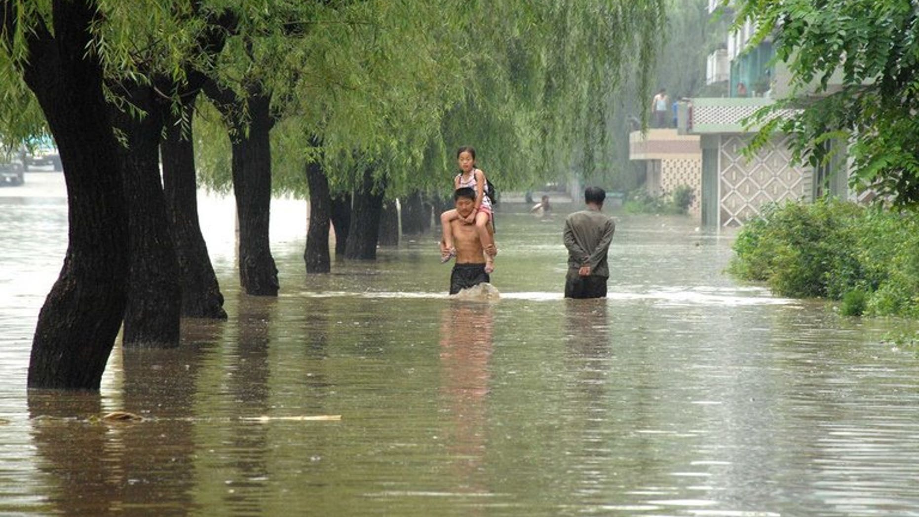 This file photo, taken by North Korea's official Korean Central News Agency in July, 2012, shows a road and houses being flooded at Anju city in South Phongan province, caused by typhoon and heavy downpour. Decades of deforestation and decrepit infrastructure have left N.Korea particularly vulnerable to floods, which led to some 170 deaths last summer.