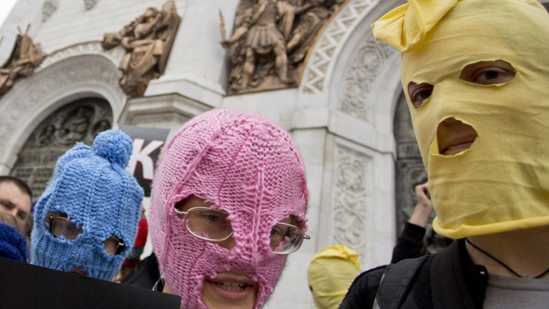 Supporters of punk group Pussy Riot, wearing the group's trademark coloured balaclavas, outside the Church of Christ the Saviour in central Moscow on August 15, 2012. A man stabbed to death a Russian priest who was deeply critical of Orthodox Church leadership and had supported the activist punk rock group Pussy Riot, police said on Tuesday.