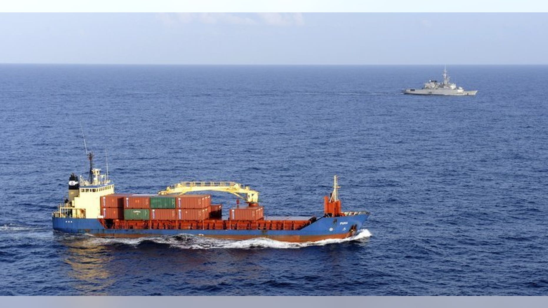 A cargo ship carrying sensitive cargo is escorted by a French military frigate in the Gulf of Aden on January 11, 2009. Britain has issued the highest possible security alert to British shipping companies operating off the coast of Yemen, an expert said on Tuesday, amid a worldwide terror alert focused on the country.