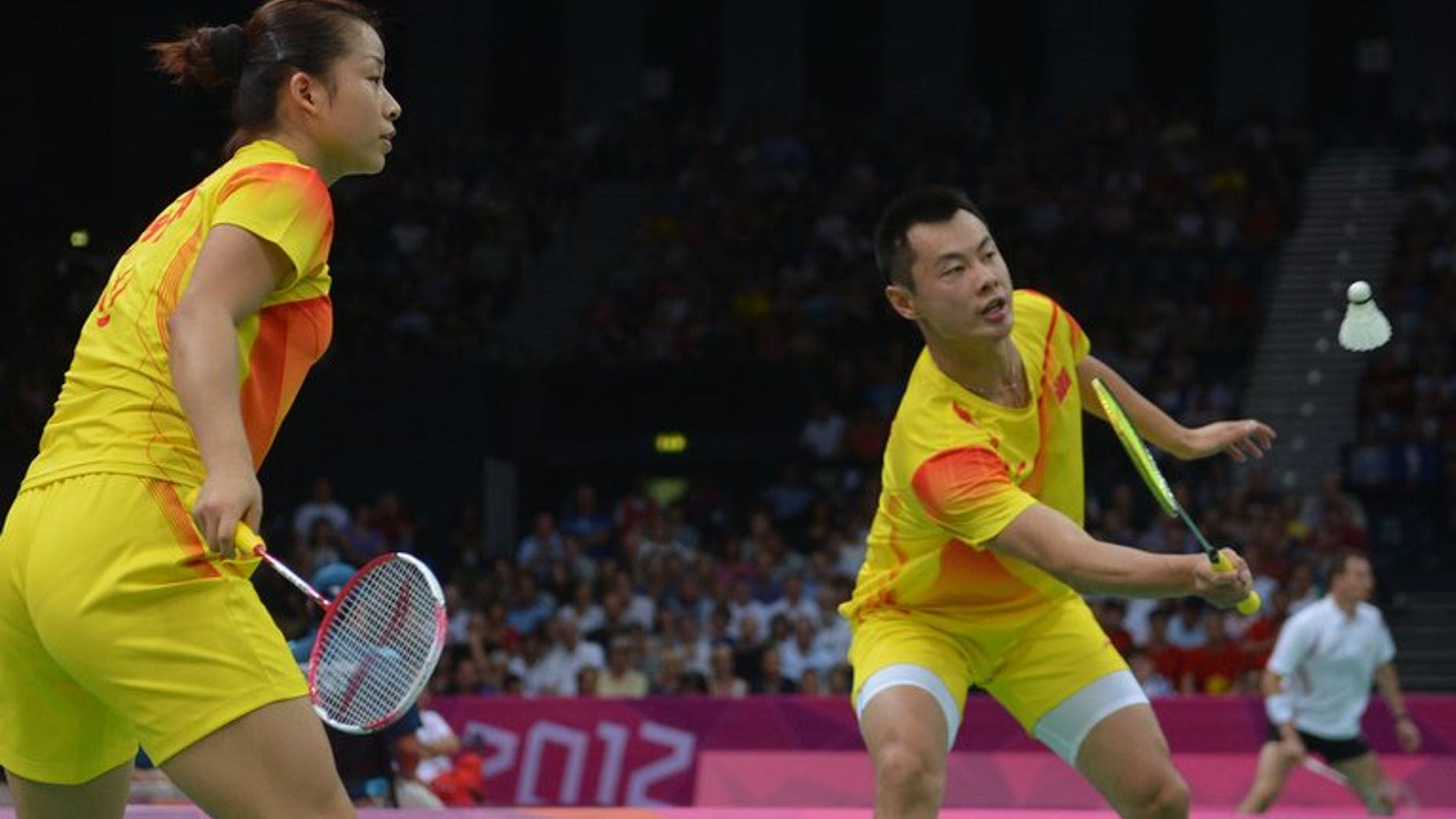 China's Ma Jin (left) watches as Xu Chen returns a shuttlecock as they compete in the mixed doubles badminton event at the 2012 Olympic Games in London, on July 30, 2012. The world's top ranked mixed doubles pair were given a scare in their opening match at the badminton world championships after dropping the first game in an intense clash.