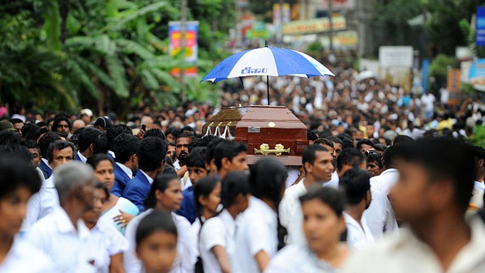 Sri Lankan students carry the coffin of their colleague, Akila Dinesh Jayawardena who was shot dead during an army crackdown against people protesting tainted ground water in the village of Weliweriya on August 4, 2013. Sri Lanka's opposition Tuesday demanded an international investigation into a deadly army crackdown on villagers who were demonstrating against contaminated water supplies.