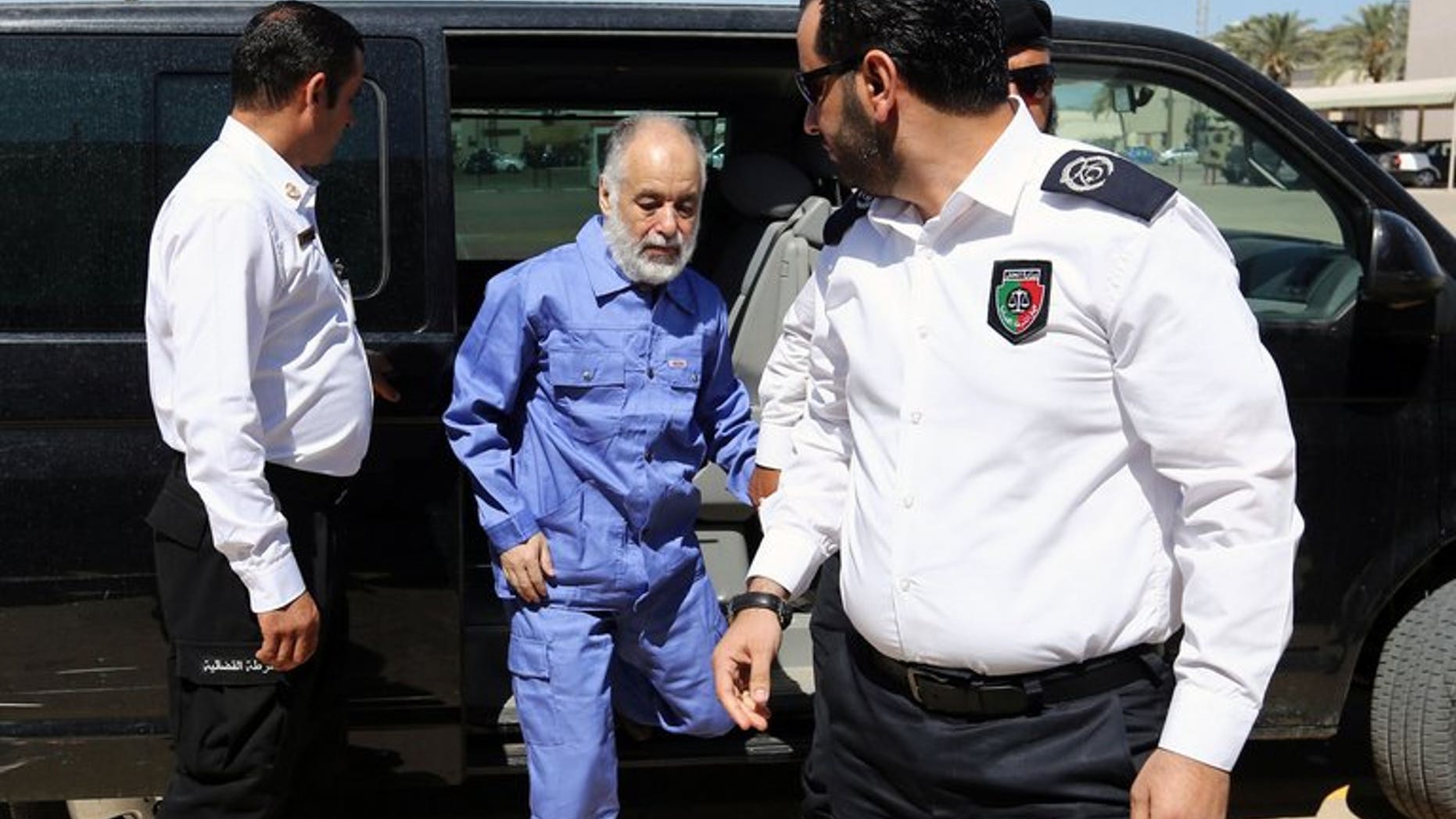 Al-Baghdadi al-Mahmudi arrives at court for a hearing in his trial on June 12 in Tripoli. French lawyers for Moamer Kadhafi's last premier called Tuesday for his trial to be postponed after they were unable to secure visas to go and defend him, amid fears of "revenge" justice in Libya.