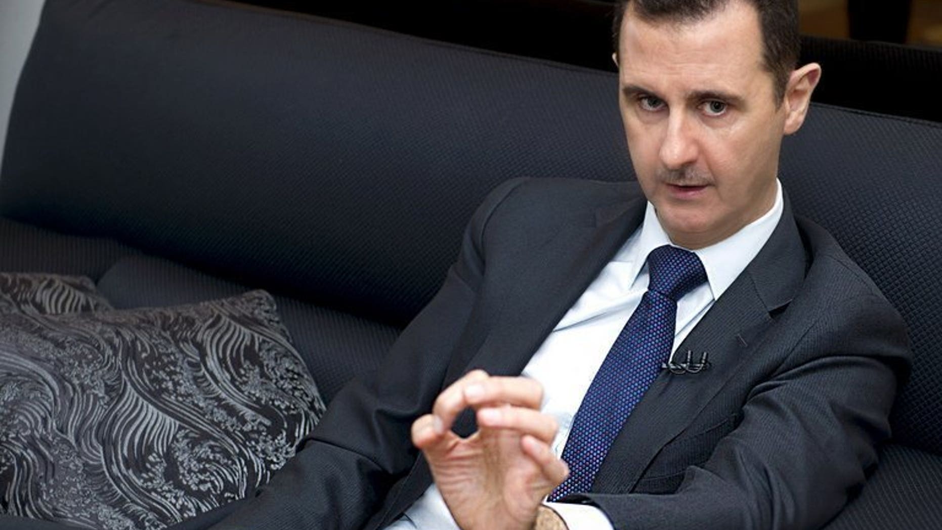 A handout picture released by the Syrian Arab News Agency (SANA) on June 17, 2013, shows Syrian President Bashar al-Assad speaking during an interview with the Frankfurter Allgemeine Zeitung newspaper in Damascus. Assad has passed a decree legalising private security firms, faced with a 29-month armed revolt against his rule that has pinned down the police, according to the SANA news agency.