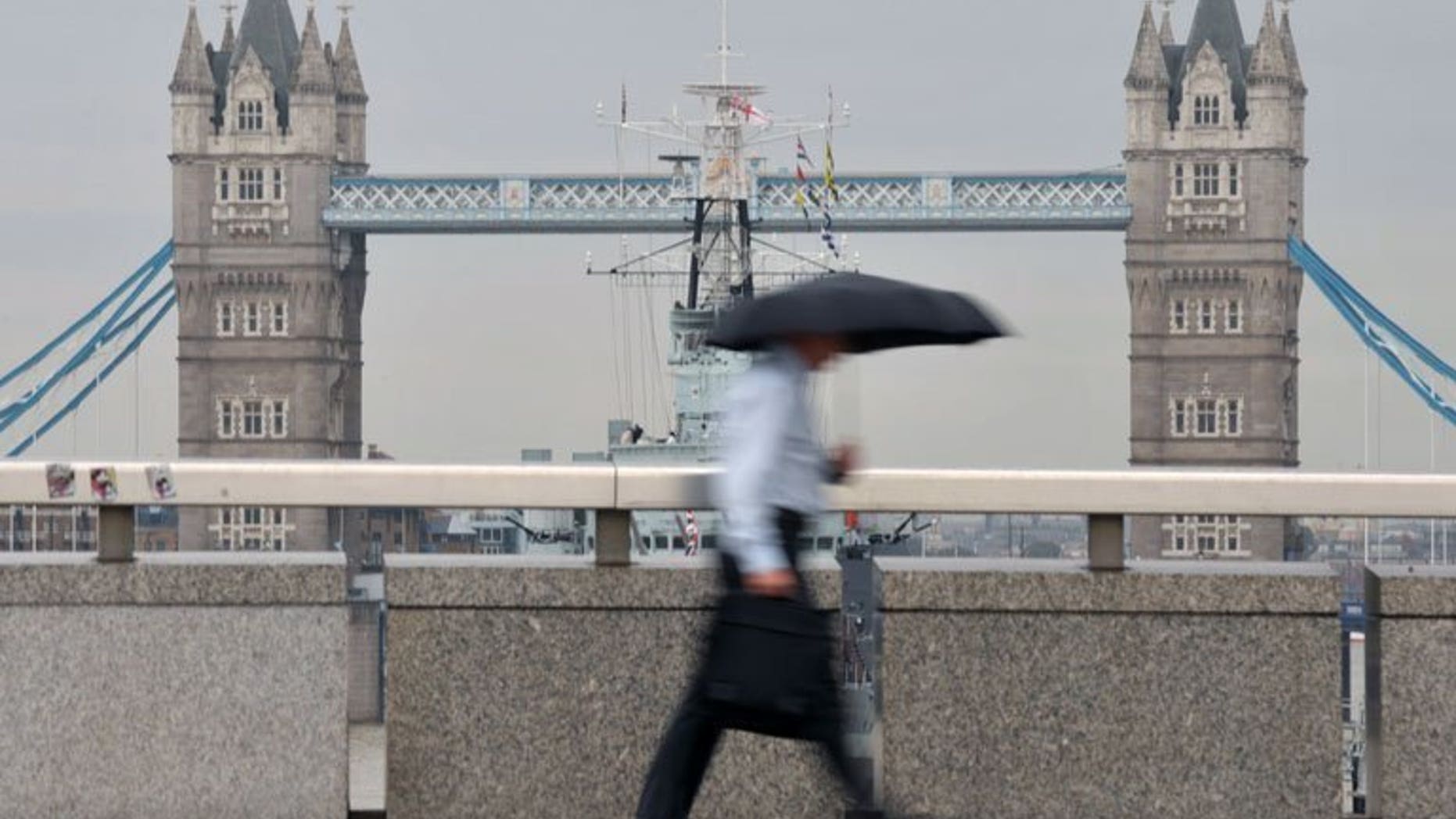 A city worker walks over London Bridge in central London. London shares closed lower on Tuesday as shares in Fresnillo plunged after its results and other miners sank in its wake, dealers said.