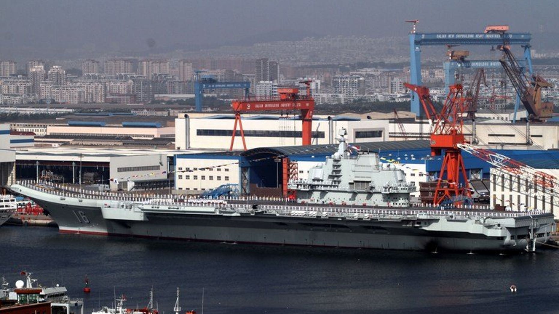 China's first aircraft carrier, the "Liaoning" sits berthed at the naval base in Dalian, northeast China's Liaoning province on September 25, 2012. No-one can contain China's rise, a leading Beijing foreign policy thinker said Tuesday, warning Manila and Tokyo that they had been mistakenly emboldened by Washington in territorial disputes with his country.