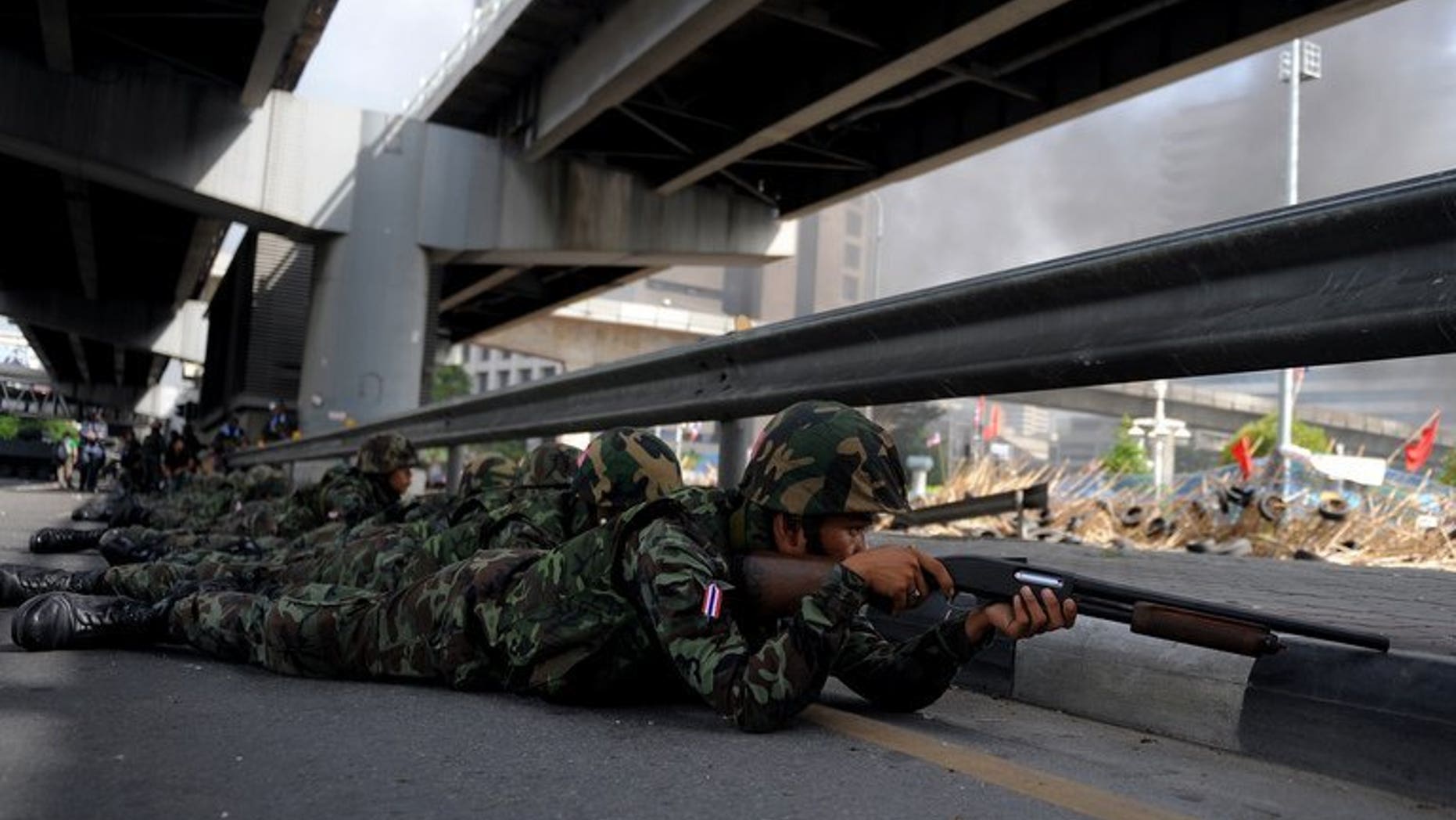 Thai soldiers take position outside the Red Shirt anti-government protesters' camp in Bangkok on May 19, 2010. Six Thais, including a nurse and two rescue volunteers, shot dead while sheltering in a Bangkok temple declared a safe zone during 2010 protests were killed by army bullets, a court ruled Tuesday.
