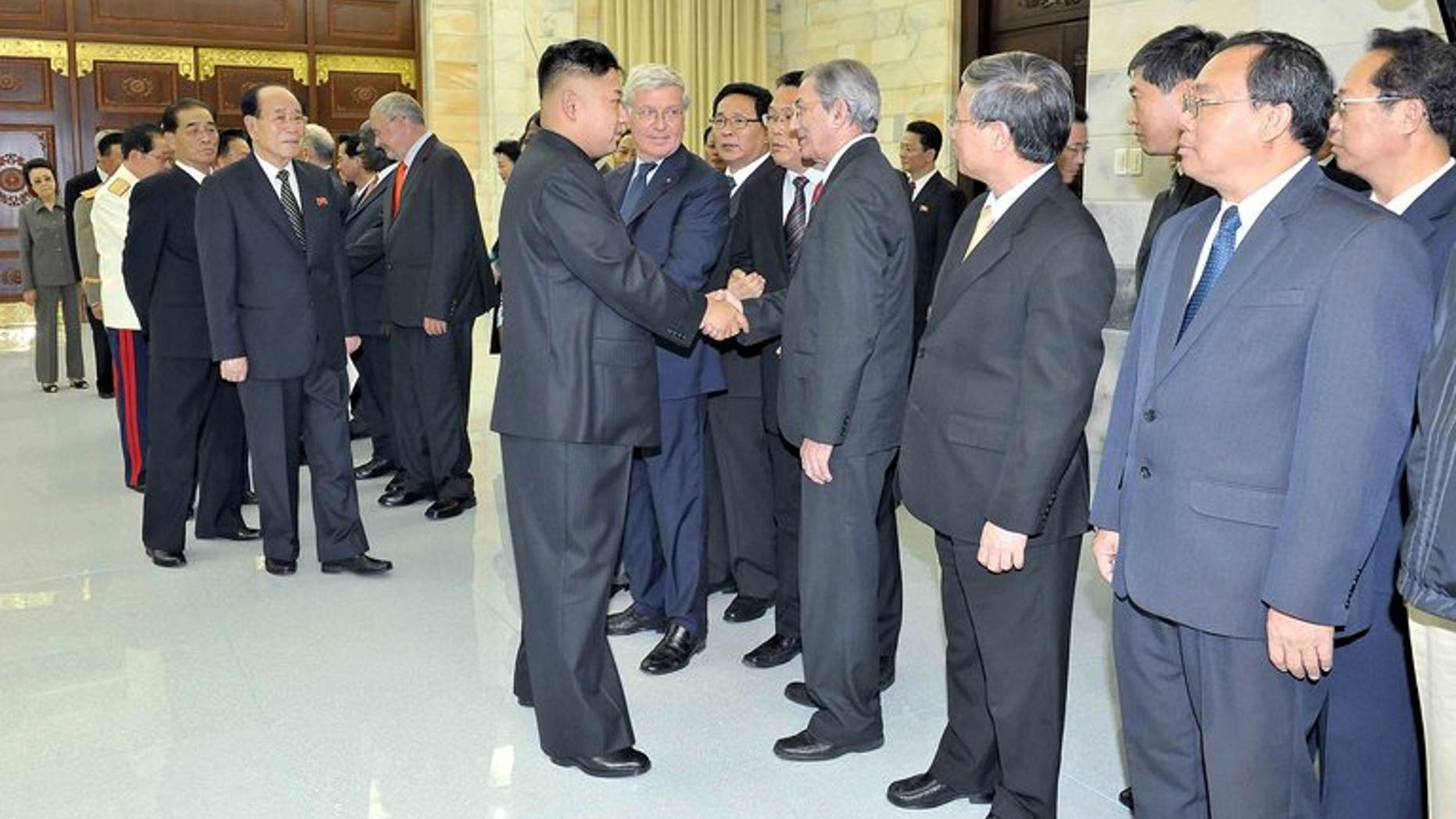This undated photo released by North Korea's official Korean Central News Agency (KCNA) on July 28, 2013 shows North Korean leader Kim Jong-Un (centre L) welcoming head of the International Department of the Central Committee of the Communist Party of Cuba Jose Ramon Balaguer (centre R) in Pyongyang. Cuba said it was looking forward to closer cooperation with North Korea after "favorable" talks.