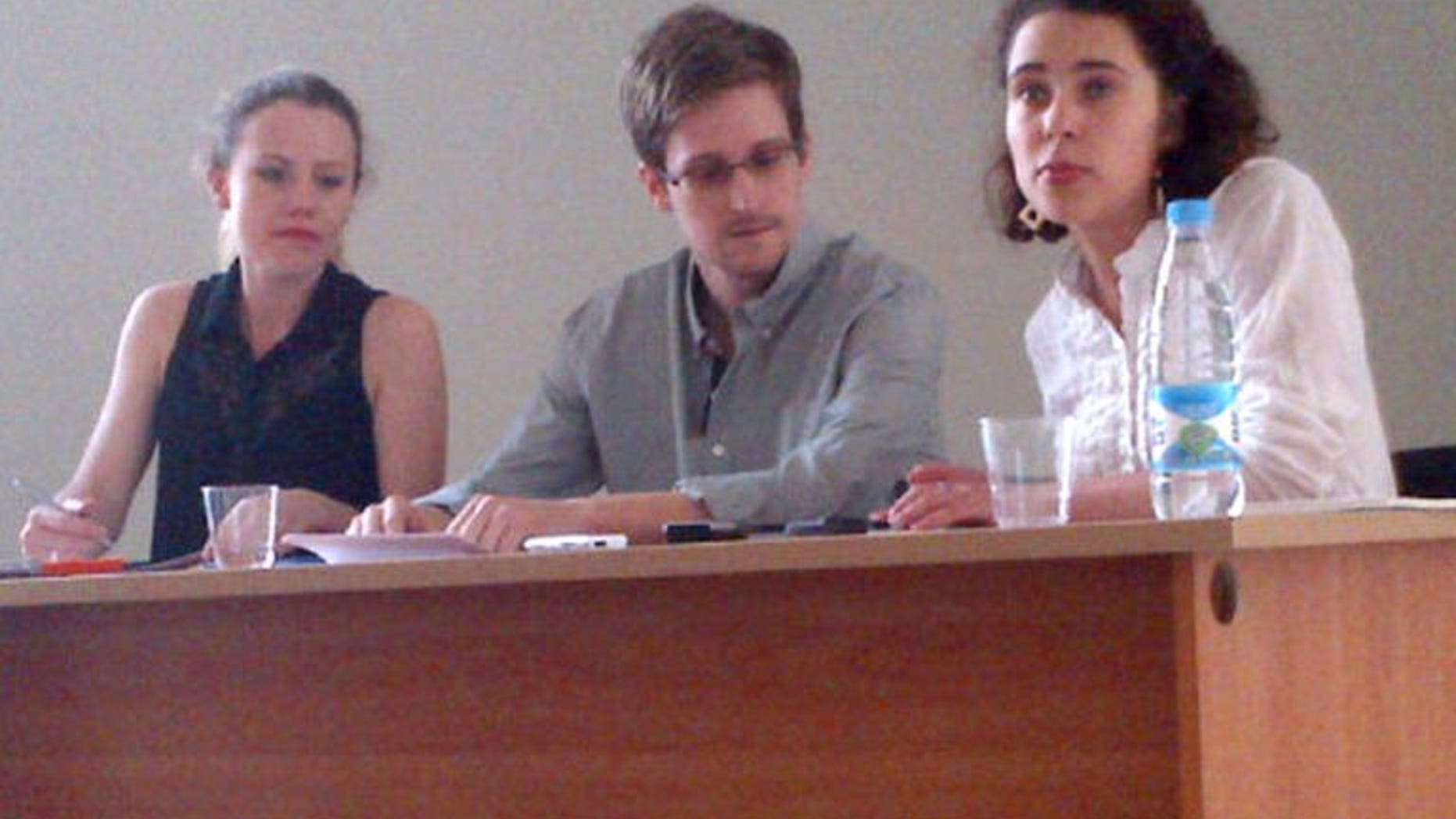 A picture released by Human Rights Watch shows Edward Snowden (C) during a meeting with rights activists, among them Sarah Harrison of WikiLeaks (L), at Moscow's Sheremetyevo airport, on July 12, 2013. Brazil-based Guardian reporter Glenn Greenwald said Tuesday that he had received nearly 20,000 secret US government documents from intelligence leaker Snowden.
