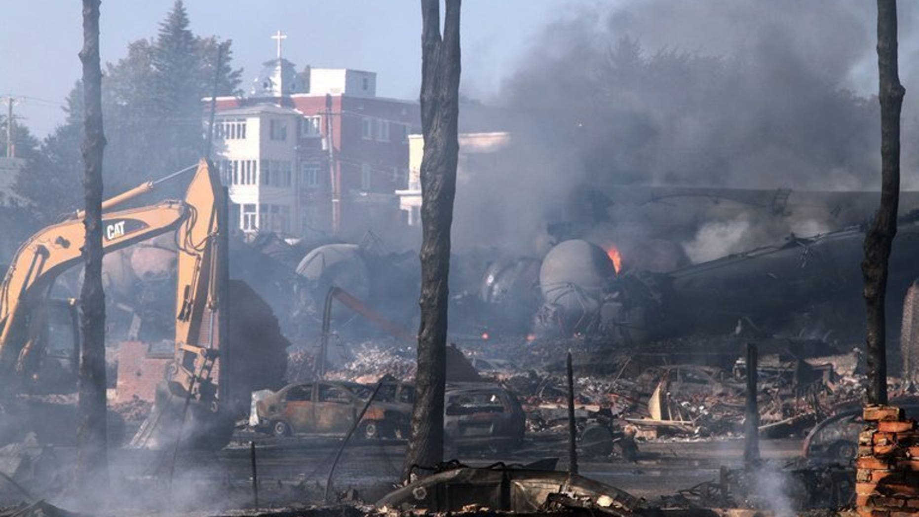 Wrecked oil tankers and debris are shown July 8, 2013 after a runaway train derailed and exploded in Lac-Megantic, Quebec. Montreal, Maine & Atlantic , the owners of the train, have filed for bankruptcy.