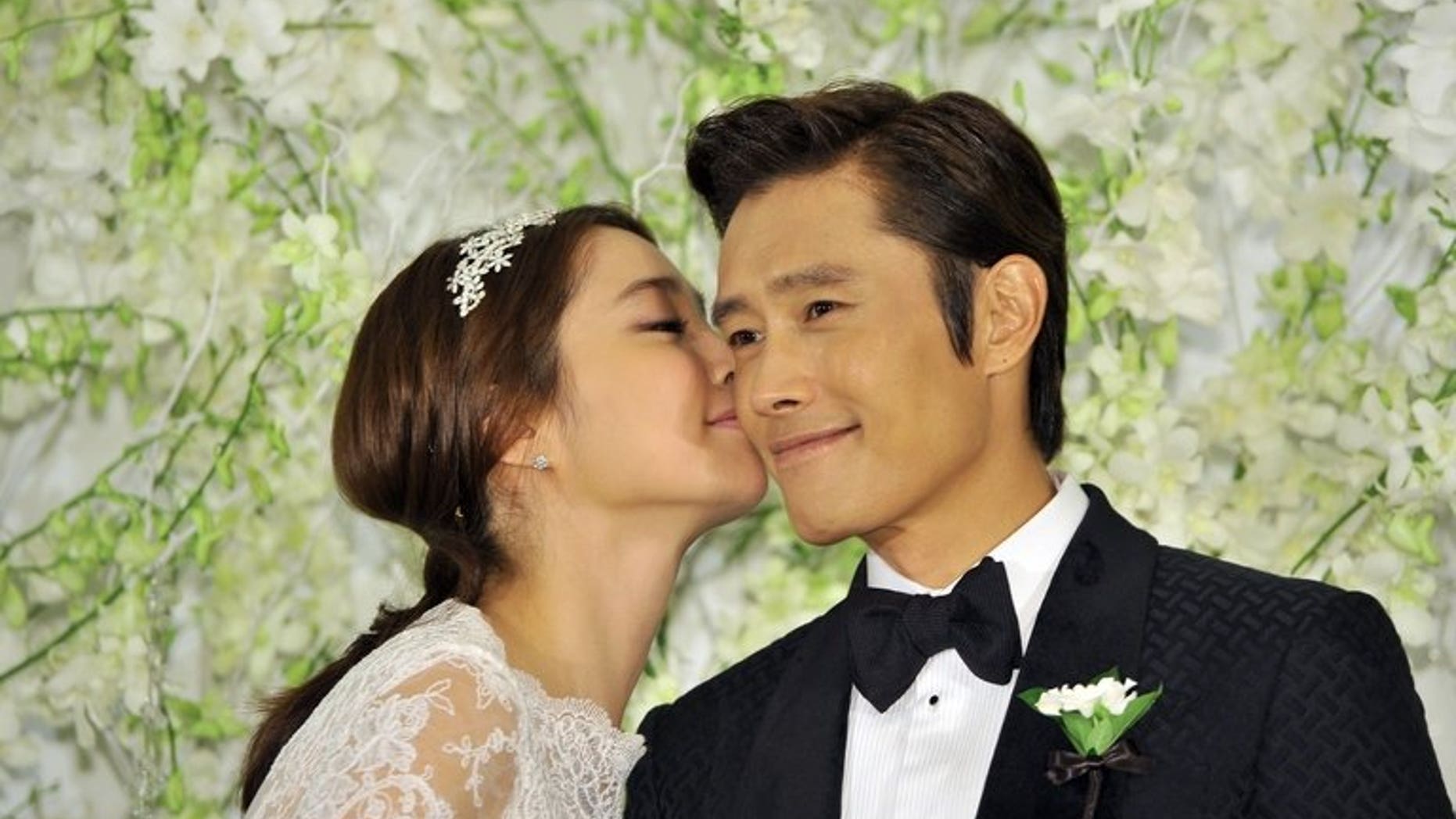 South Korean actor Lee Byung-Hun poses with actress Lee Min-Jung during a press conference before their wedding in Seoul, on August 10, 2013. Lee Byung-Hun is one of the best known faces of the "Korean Wave" of popular culture.