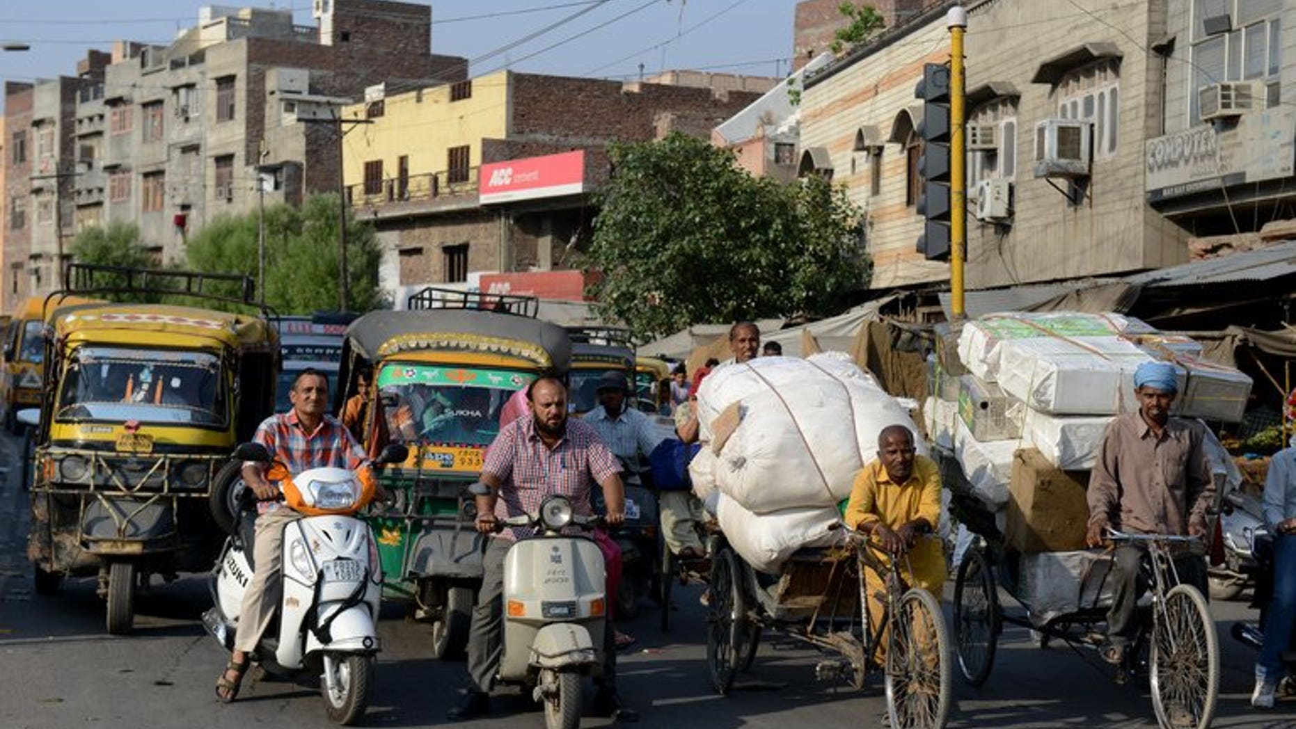 This file photo shows a busy intersection in the centre of Amritsar, on May 16, 2013. India's car sales slid by over seven percent in July, marking a record ninth straight month of decline, industry data showed on Monday, as an economic slump and high borrowing costs discouraged buyers.