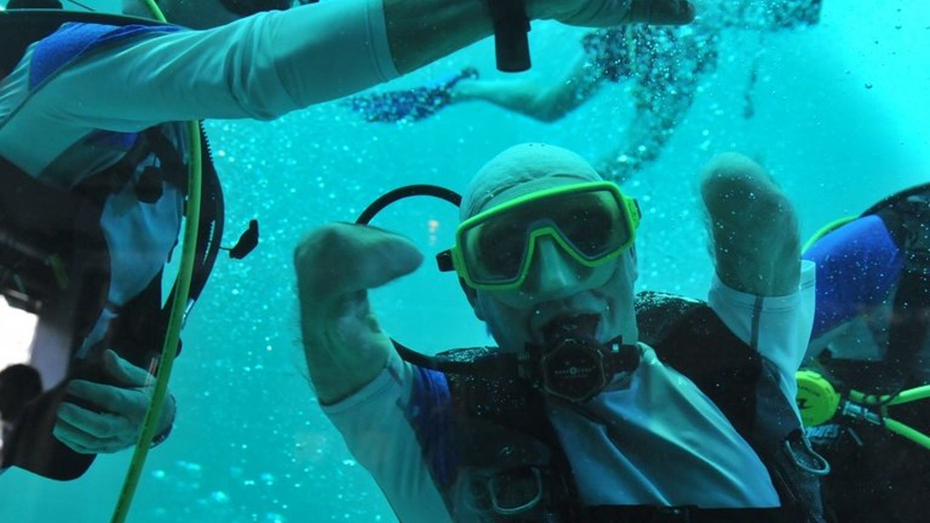 Philippe Croizon celebrates underwater on January 10, 2013 after becoming the first quadruple amputee to dive to a depth of 33 metres, in the deepest swiming pool in the world in Brussels.