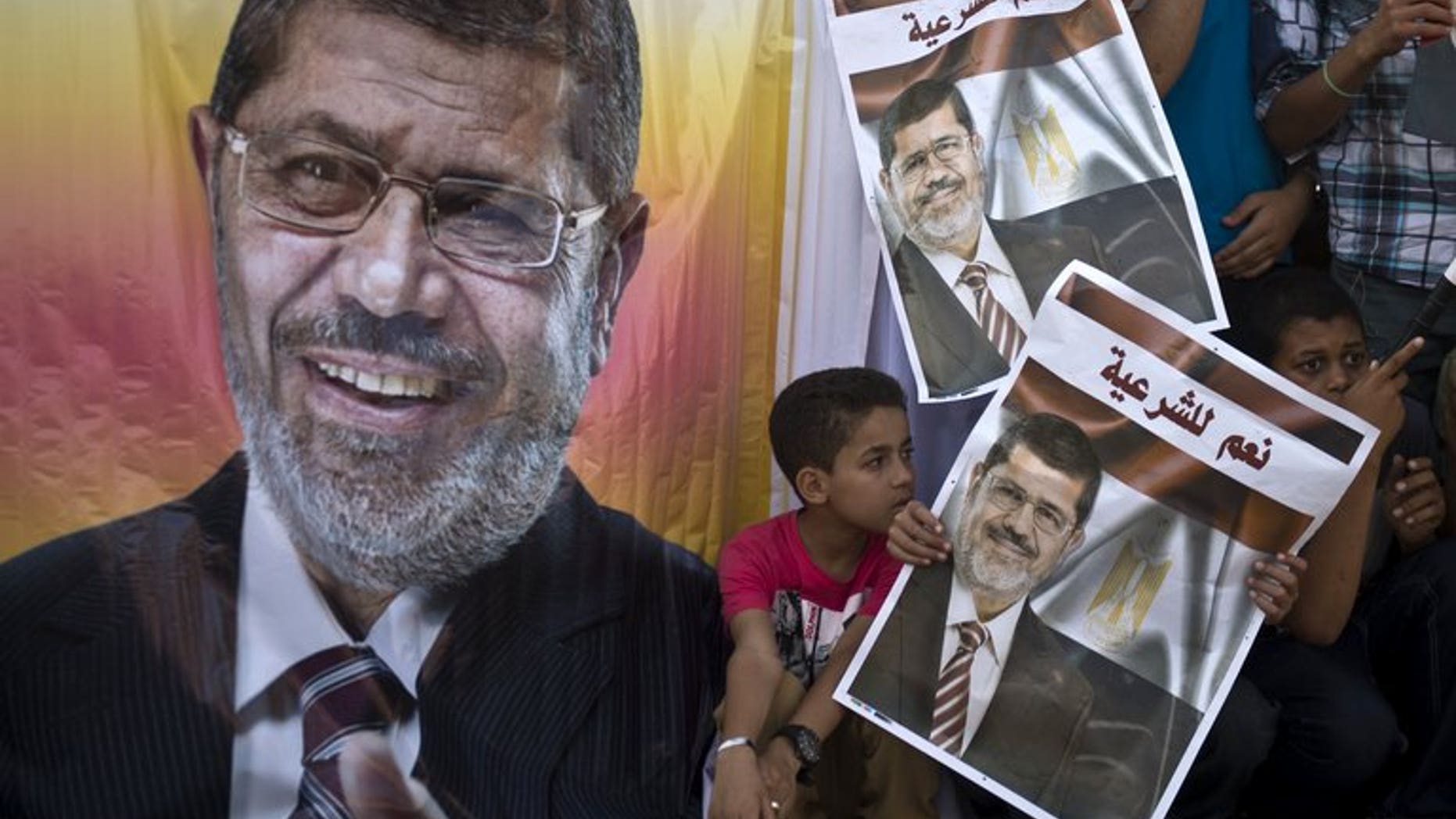 Supporters of deposed Egyptian president Mohamed Morsi watch a football match between the two main Cairo protest camps by members of the Muslim Brotherhood and supporters of the ousted Islamist leader in Cairo on August 11, 2013. Egypt's judiciary said Monday it was extending ousted president Mohamed Morsi's detention for a further 15 days pending an investigation into his collaboration with Hamas.
