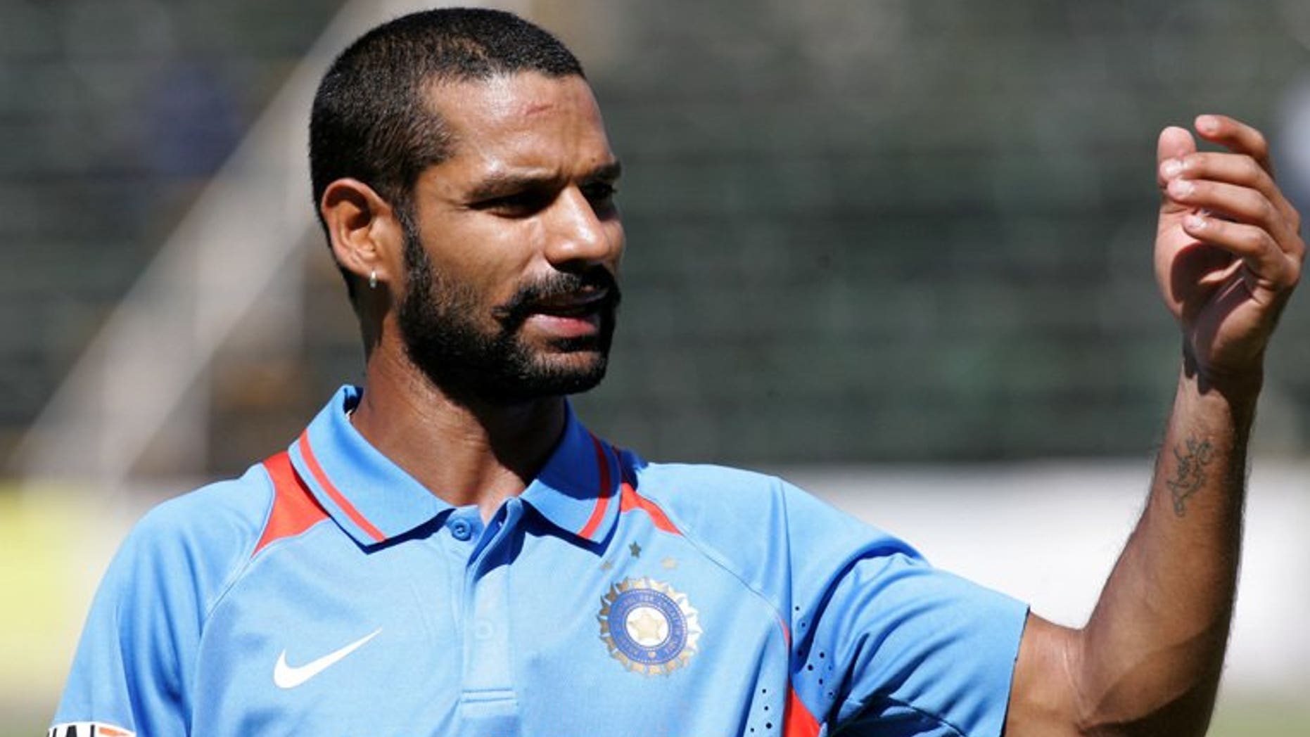 Indian batsman Shikhar Dhawan gestures for drinks during a one-day inernational against Zimbabwe at the Harare Sports Club, on July 26, 2013. Dhawan has struck 248 runs as India A made 433-3 to win a 50-over match against South Africa A.