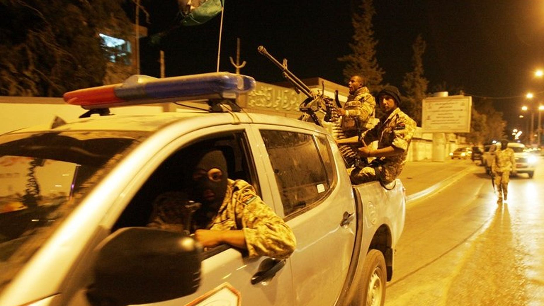 Members of the Libyan security forces drive through Benghazi, in May 2013. A journalist at a private Libyan television channel narrowly survived an assassination attempt in the restive Benghazi, a colleague working for the Libya al-Ahrar TV network told AFP.