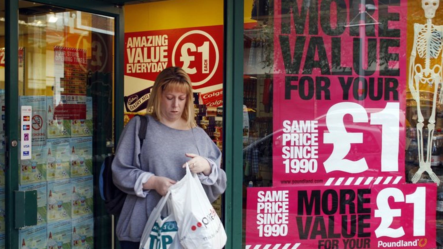 A woman leaves a shop in Reading on October 1, 2008. Britain's annual inflation fell in July from a 14-month peak reached in June, official data showed.