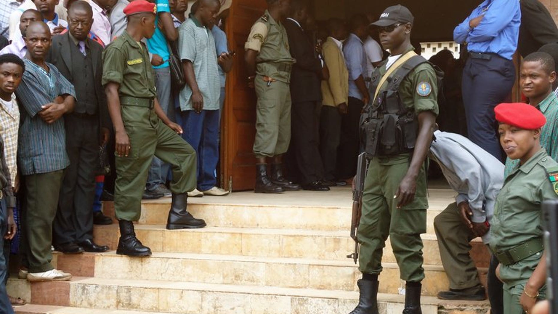 Policemen stand at the entrance of a court in Yaounde on July 16, 2012. A Cameroonian court has sentenced a former health minister to 20 years in prison for corruption over a fake contract to deliver mosquito nets to hospitals, legal sources said.