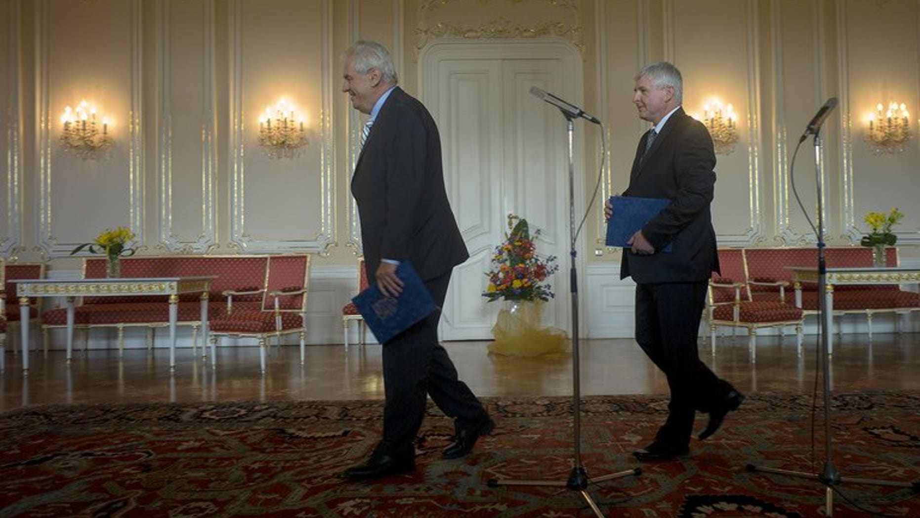 Czech President Milos Zeman (L) and Prime Minister Jiri Rusnok leave after Zeman accepted the resignation of Rusnok and his cabinet on August 13, 2013 at Prague Castle in Prague. The Czech government formally resigned on Tuesday after losing a confidence vote last week, ahead of snap elections to drag the country out of a deepening political crisis.