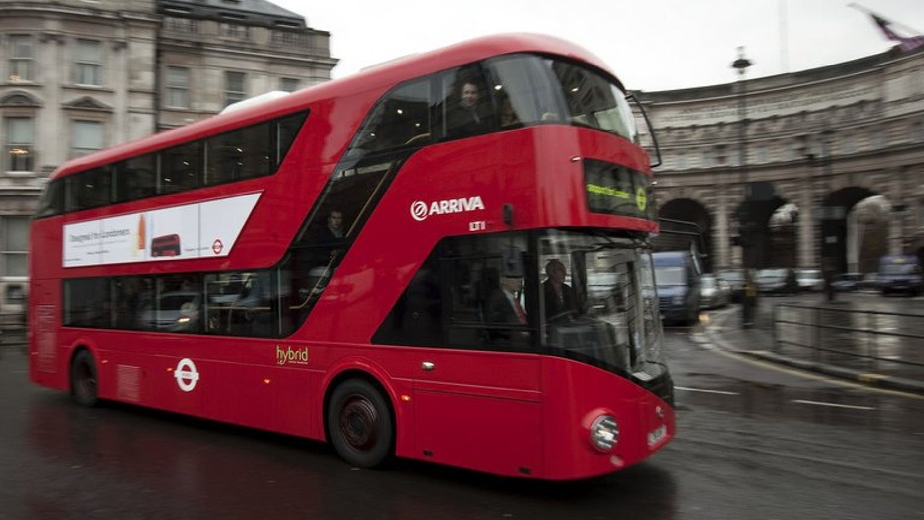A bus drives along a street in central London on December 16, 2011. There's a screaming head by Francis Bacon at the bus stop, and a landscape by John Constable in a shopping centre -- just some of the art forming part of a novel exhibition in Britain.