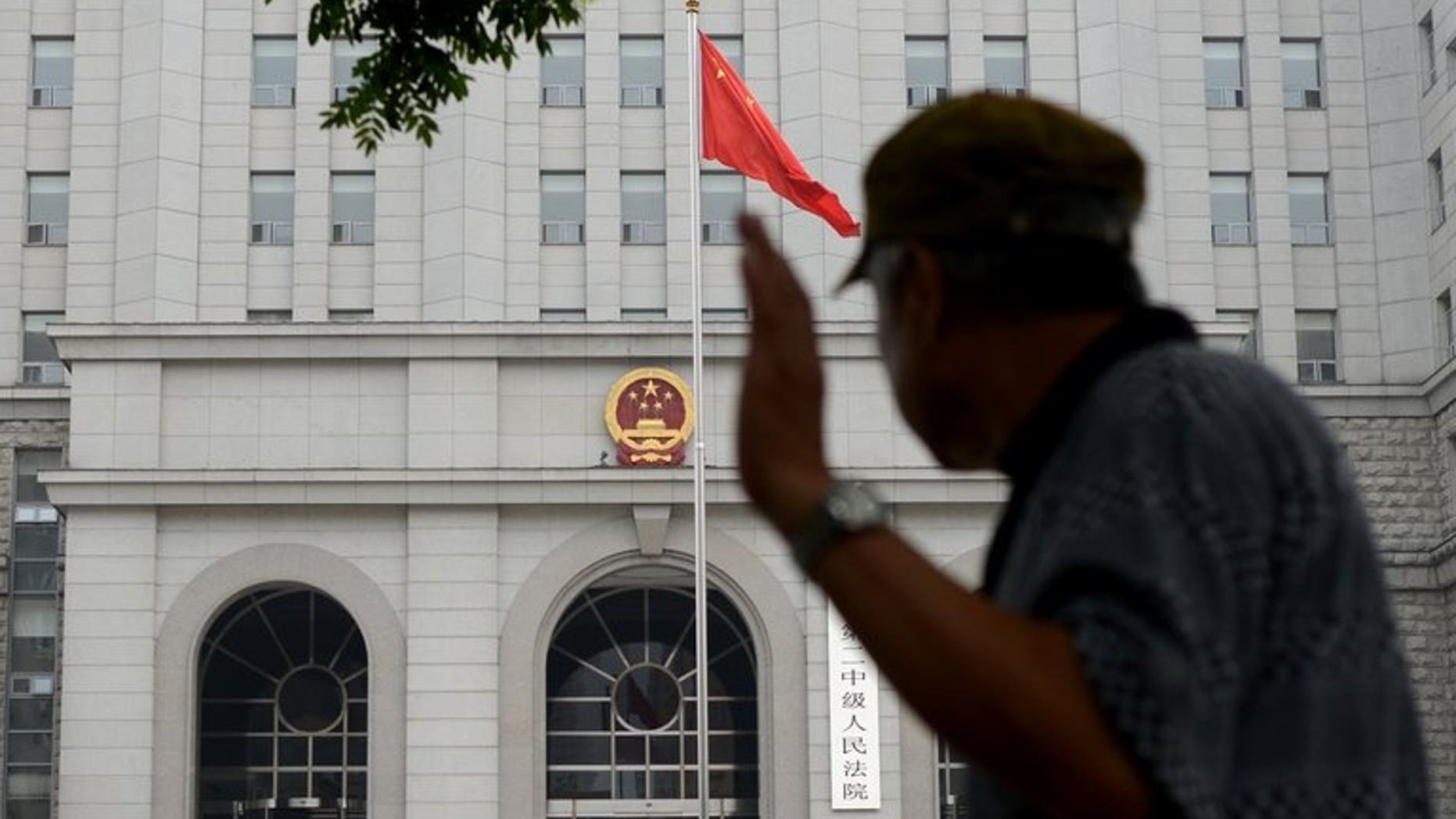 A Chinese civilian walks past a courthouse in Beijing, on July 8, 2013. China for the first time has issued guidelines aimed at preventing wrongful or unjust court judgements in response to high-profile judicial scandals, state media reported.