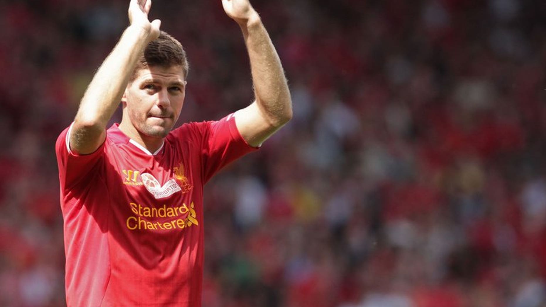 Liverpool captain Steven Gerrard waves to fans at Anfield Stadium in Liverpool, on August 3, 2013. Gerrard dealt a blow to Arsenal's pursuit of Luis Suarez on Tuesday by declaring that his unsettled team-mate will not be allowed to join another English club.