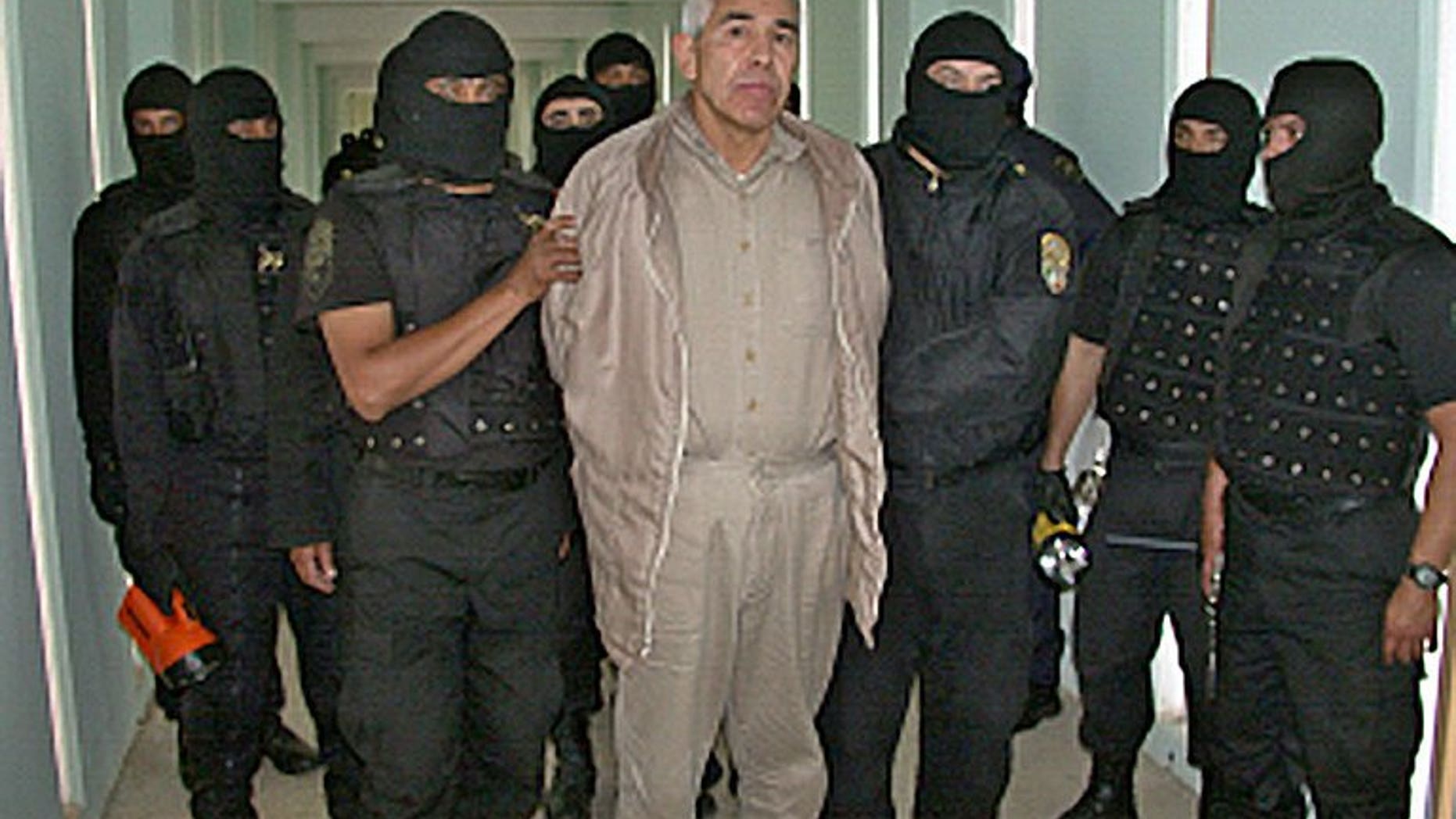 This file photo shows Rafael Caro Quintero (C), a drug lord convicted of killing a US drug agent in 1985, under custody at the 'Puente Grande' prison in Guadalajara, on January 29, 2005. Caro Quintero had another 12 years to go in his sentence, and could have faced additional charges in the US, but on August 7 a judge in the western state of Jalisco ordered his release on a technicality.