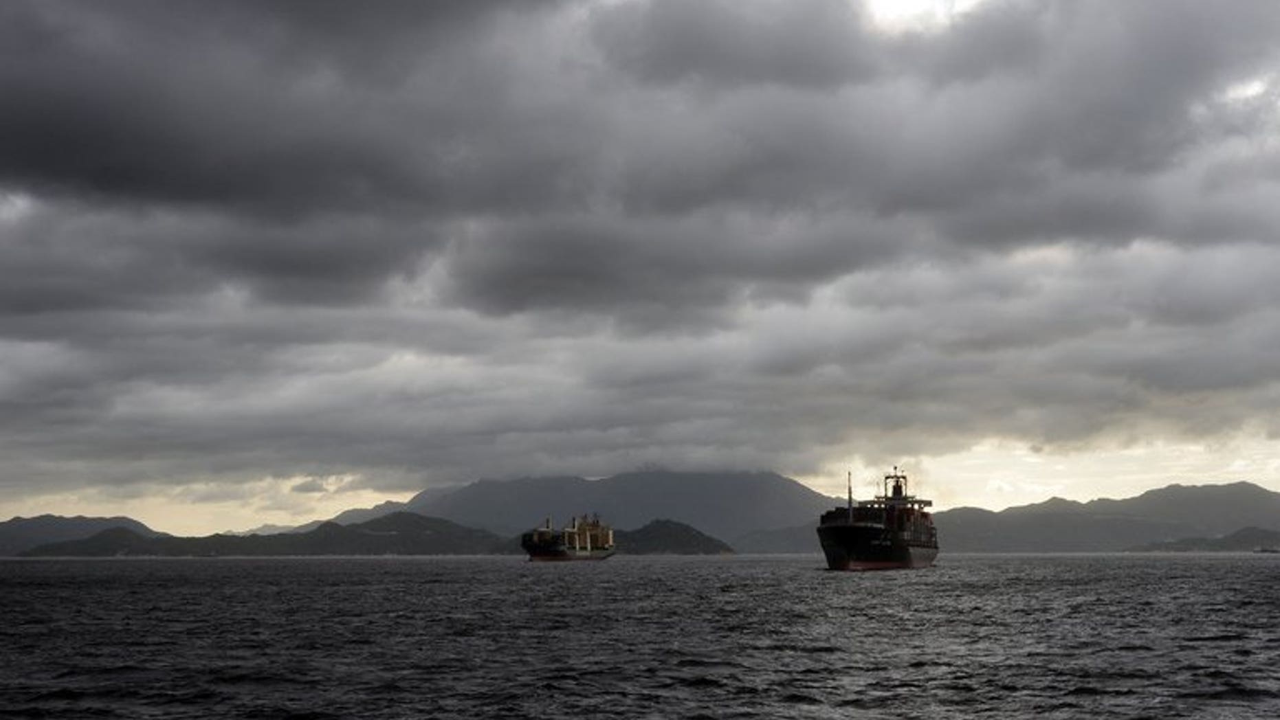 Cargo ships sail in heavy rains as a tropical storm passes over Hong Kong, on August 2, 2013. Helicopter teams have helped save all 21 crew from a cargo ship that sank off Hong Kong in a powerful typhoon that generated waves of up to 15 metres (50 feet).