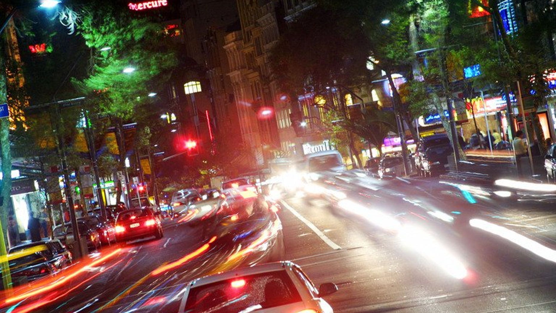 Cars and people make their way up and down Auckland's Queen Street on July 1, 2003. A New Zealand woman drove for hundreds of kilometres (miles) while asleep at the wheel, sending texts from her mobile phone along the way, police said Wednesday.