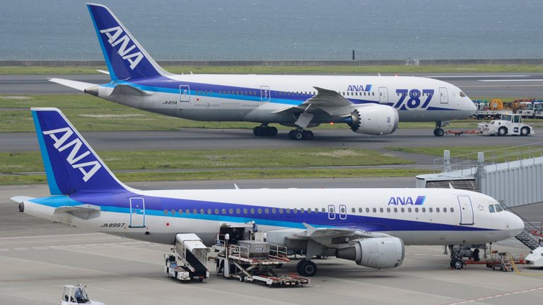 A Dreamliner passenger plane (top) of Japan's All Nippon Airways (ANA) is towed on the tarmac at Haneda Airport in Tokyo on April 30, 2013. ANA said Wednesday it had found defective wiring in a fire-extinguishing system on three of its Boeing Dreamliners, prompting rival Japan Airlines to abort a Helsinki-bound flight.