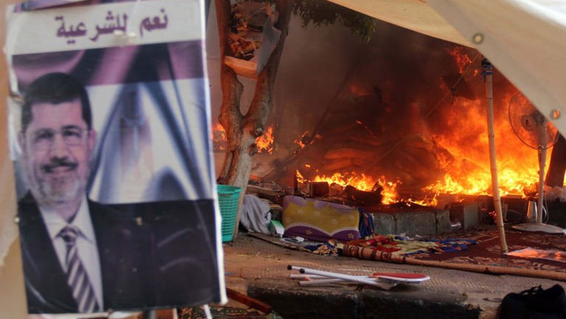 A protest camp is torched in Cairo's al-Nahda Square, on August 14, 2013. Supporters of deposed Islamist president Mohamed Morsi have torched a church in Sohag in a reprisal attack after police dispersed demonstrations in Cairo, according to the MENA state news agency.