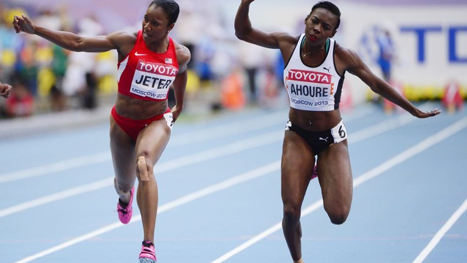 US's Carmelita Jeter and Ivory Coast's Murielle Ahoure (right) compete in heat 2 of the women's 100 metres semi-final at the 2013 IAAF World Championships at the Luzhniki stadium in Moscow on August 12, 2013. Ahoure made history in becoming the first female African sprinter to win a medal in the history of the World Athletics Championships in the 100 metres.