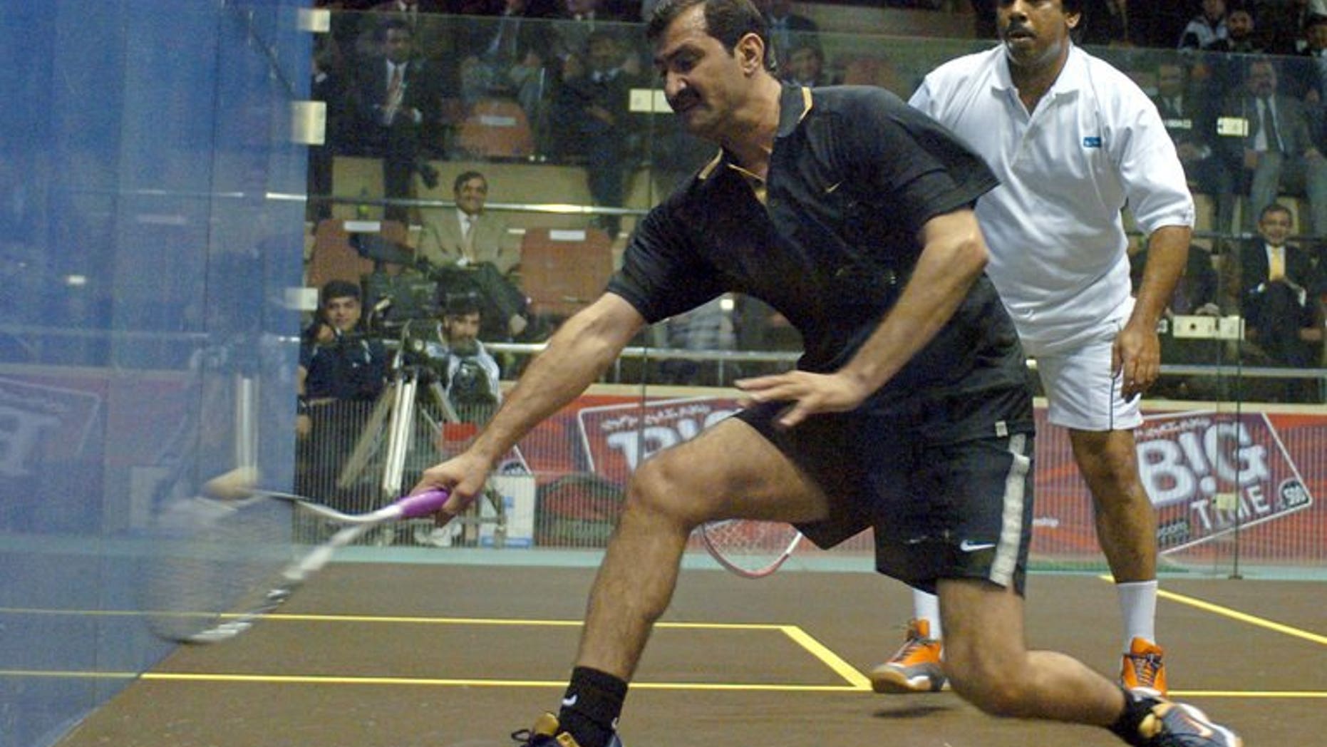 Pakistani squash legends Jahangir Khan (right) and Jansher Khan play during a friendly match at the Mushaf Squash Complex in Islamabad, 14 December 2005. Khan says the country must do more to improve its image and stop the rest of the world thinking of Pakistanis as "terrorists".