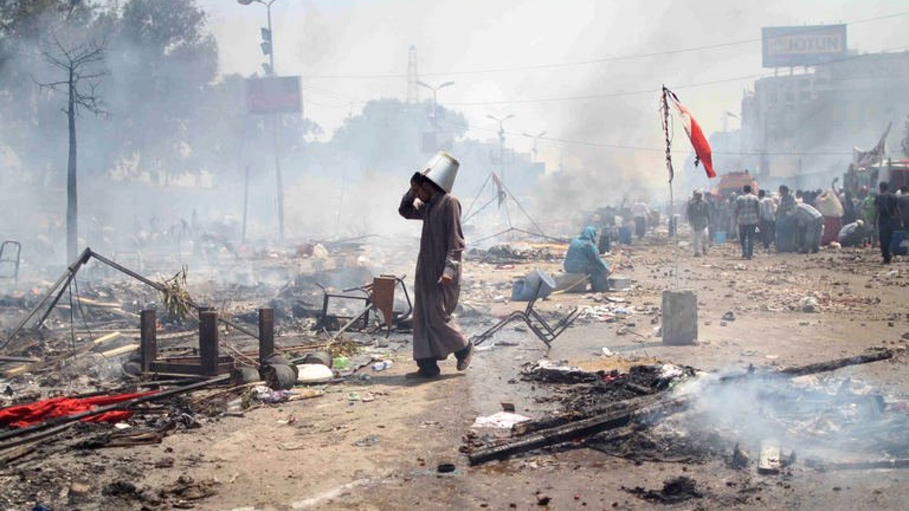 A supporter of Egypt's ousted president Mohamed Morsi walks through the debris following clashes with police in Cairo on August 14, 2013. Egyptian security forces were in "total control" of the main protest camp of supporters of ousted president Mohamed Morsi on Wednesday after a day of deadly clashes, a security official said.