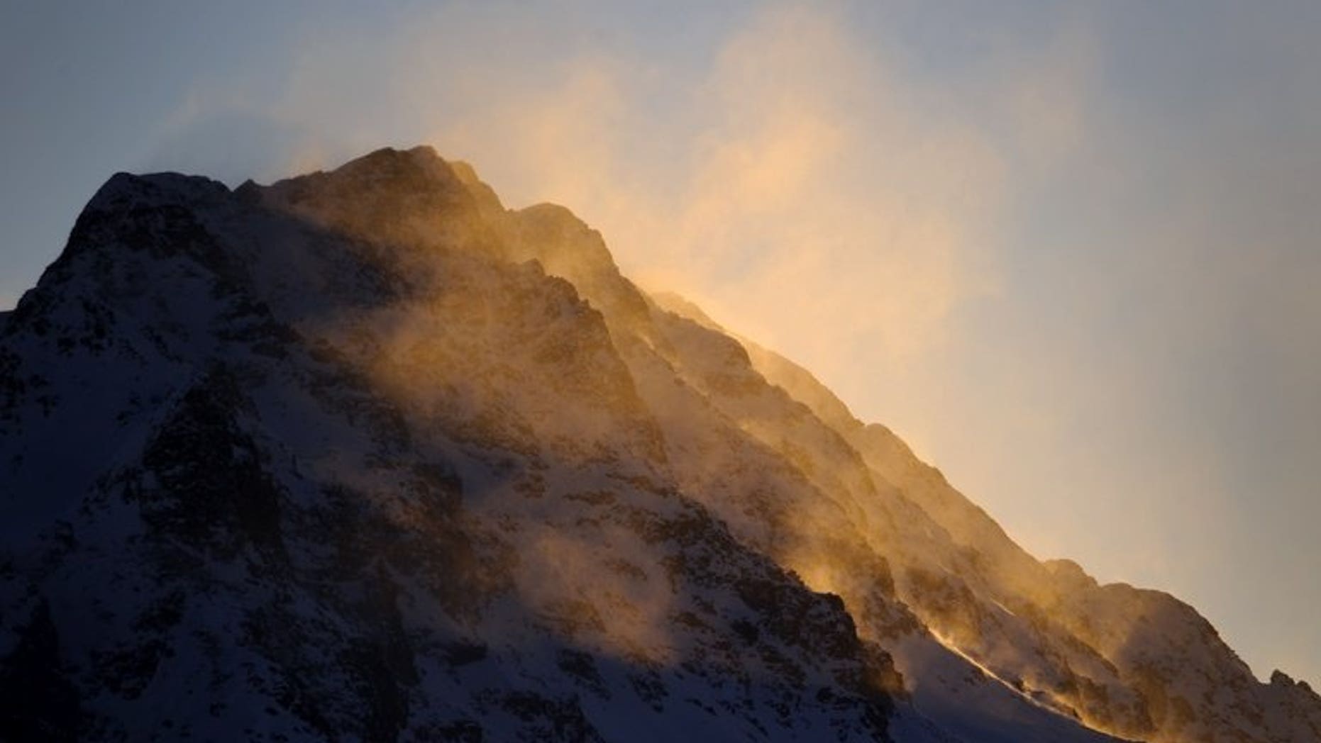 The sun rises over Swiss Alps on December 12, 2010 in St. Moritz. A British man flying in a wingsuit was killed Wednesday after plunging into a mountain ridge in the Swiss Alps, police said.