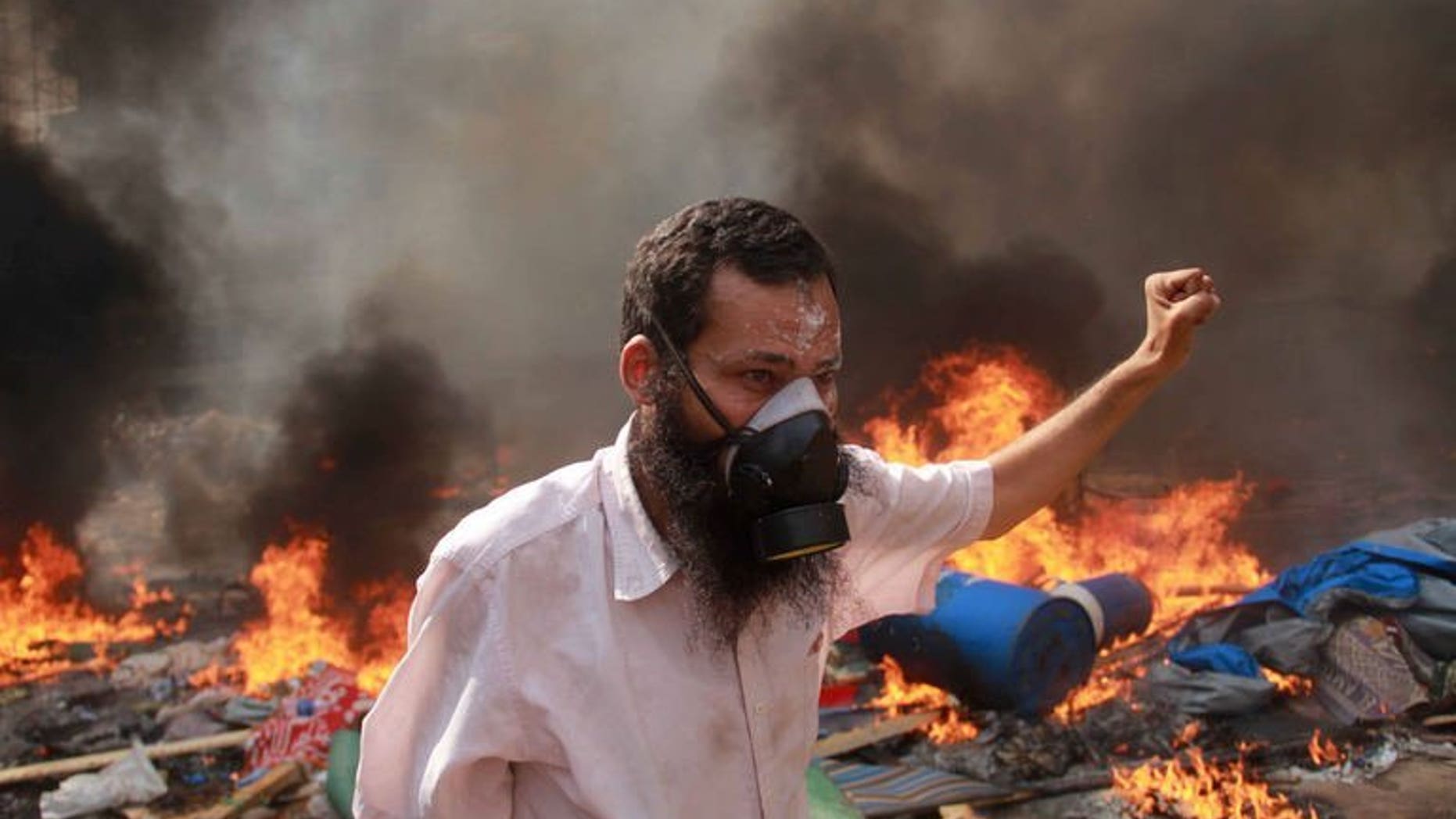 A supporter of the Muslim Brotherhood and ousted Morsi gestures during clashes with police in Cairo on August 14, 2013. Egypt's health ministry said 278 people had been killed in nationwide violence Wednesday after police cracked down on loyalists of ousted Islamist president Mohamed Morsi.