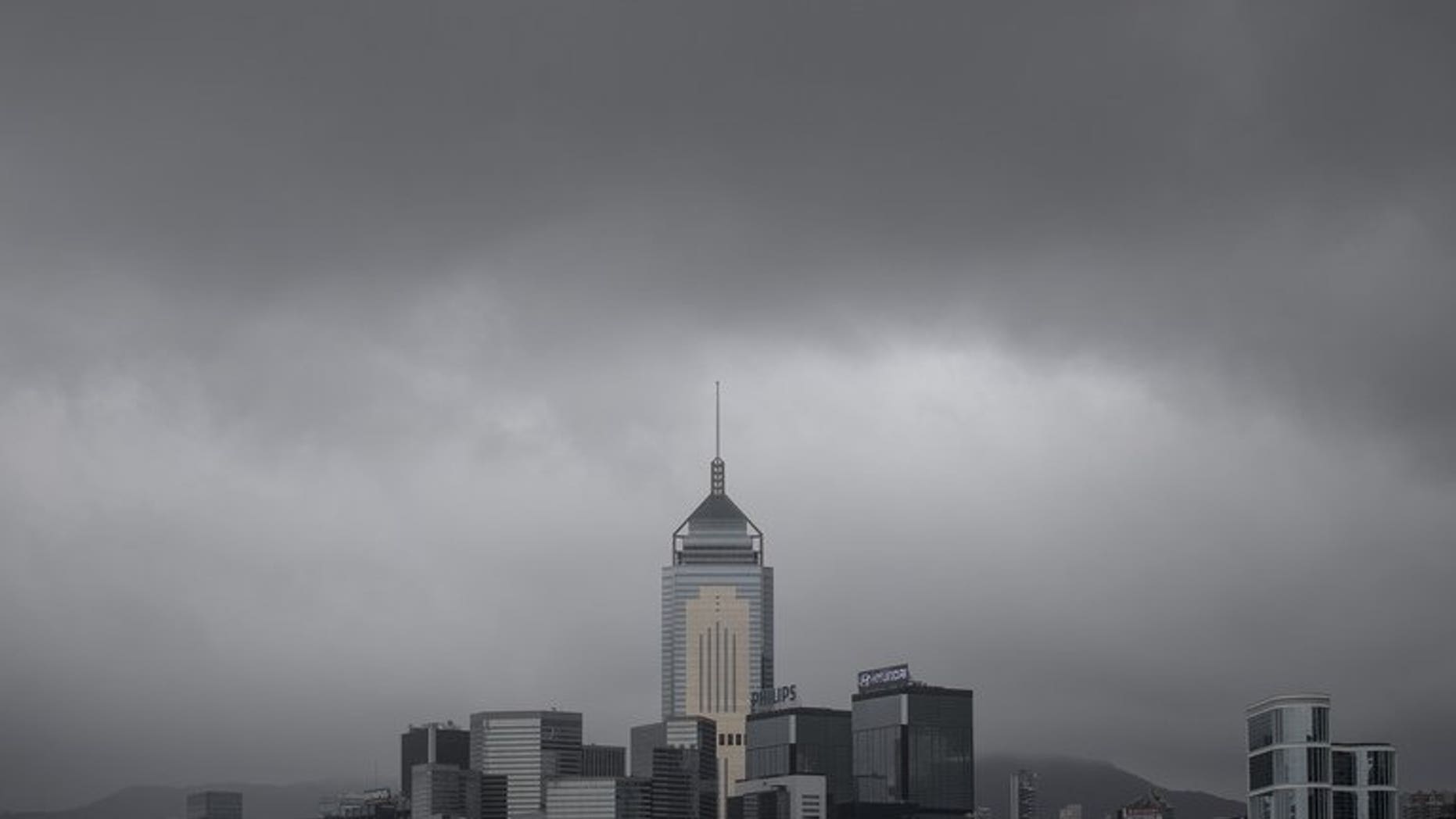 Dark clouds brought by Typhoon Utor cover the city's skyline in Hong Kong, on August 14, 2013. Utor brought high winds and rough waters to HK, shutting down schools and bringing public services to a halt.