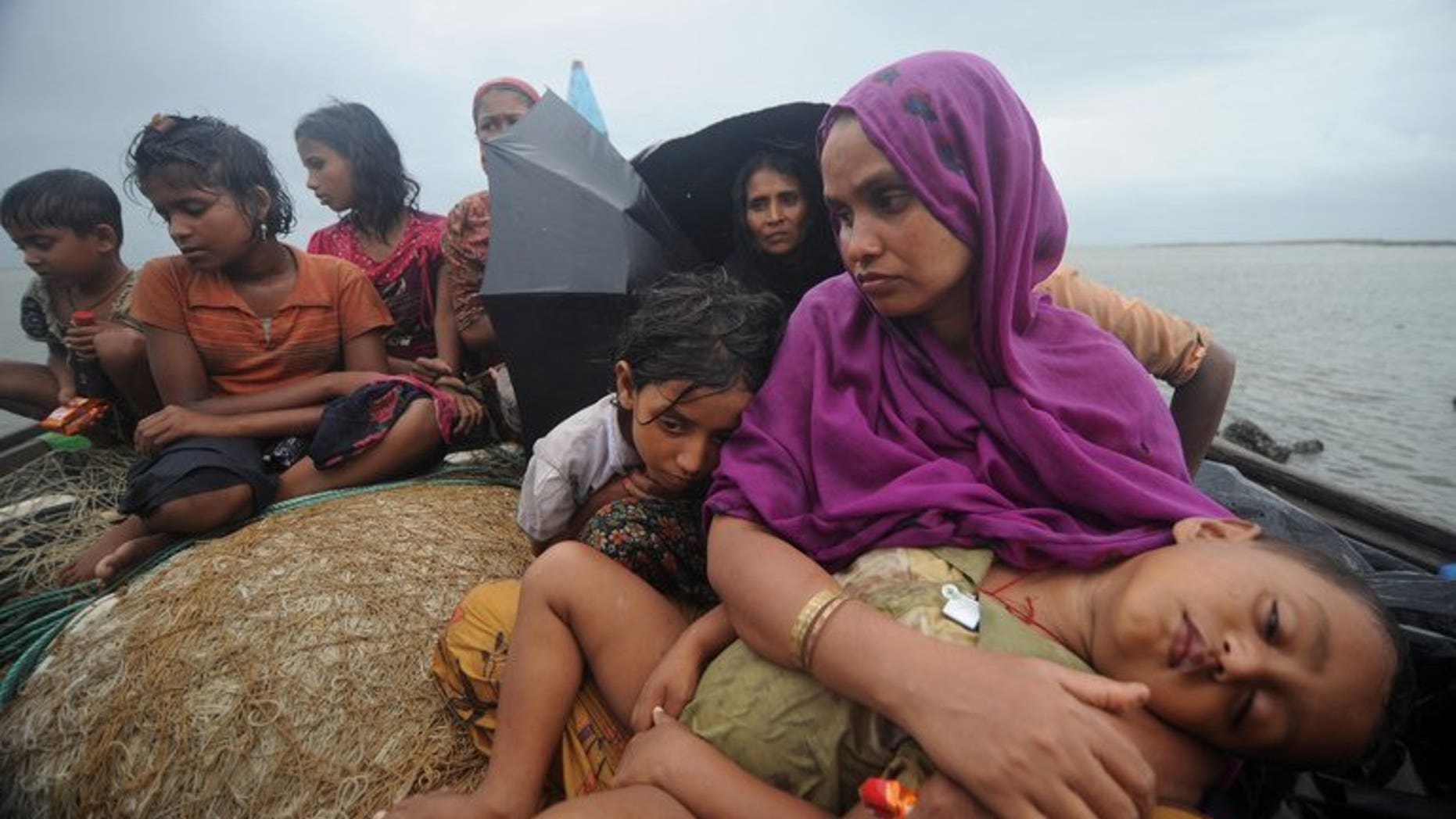 This picture taken on June 13, 2012 shows Rohingya Muslims, trying to cross the Naf river into Bangladesh to escape sectarian violence in Myanmar. Myanmar officials say six Buddhist men will face trial this month over the lynching of 10 Muslim bus passengers as sectarian unrest convulsed Rakhine state in June 2012.