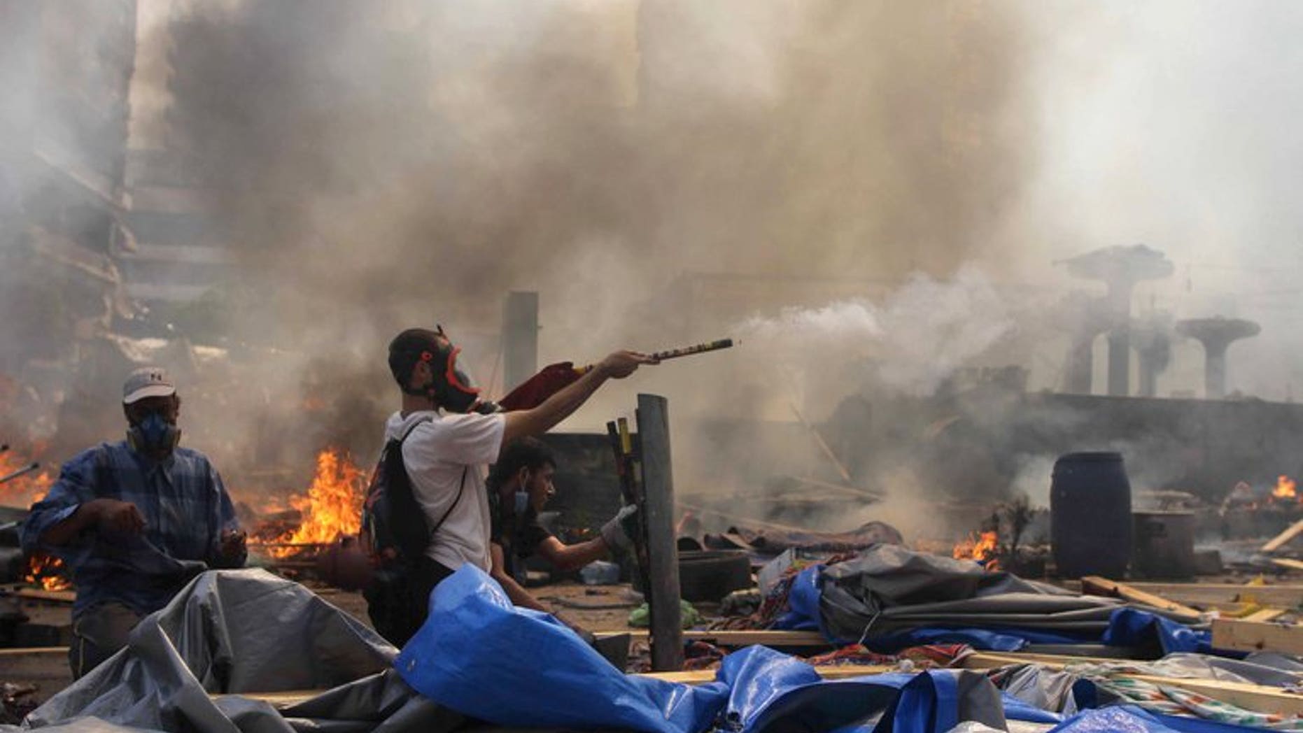 A supporter of ousted president Morsi fires fireworks towards police during clashes in Cairo on August 14, 2013. Egypt's Tamarod group, which launched the call for mass protests that led to the ousting of Islamist president Mohamed Morsi, urged all Egyptians to take to the streets on Friday to defend the country from "terrorism."