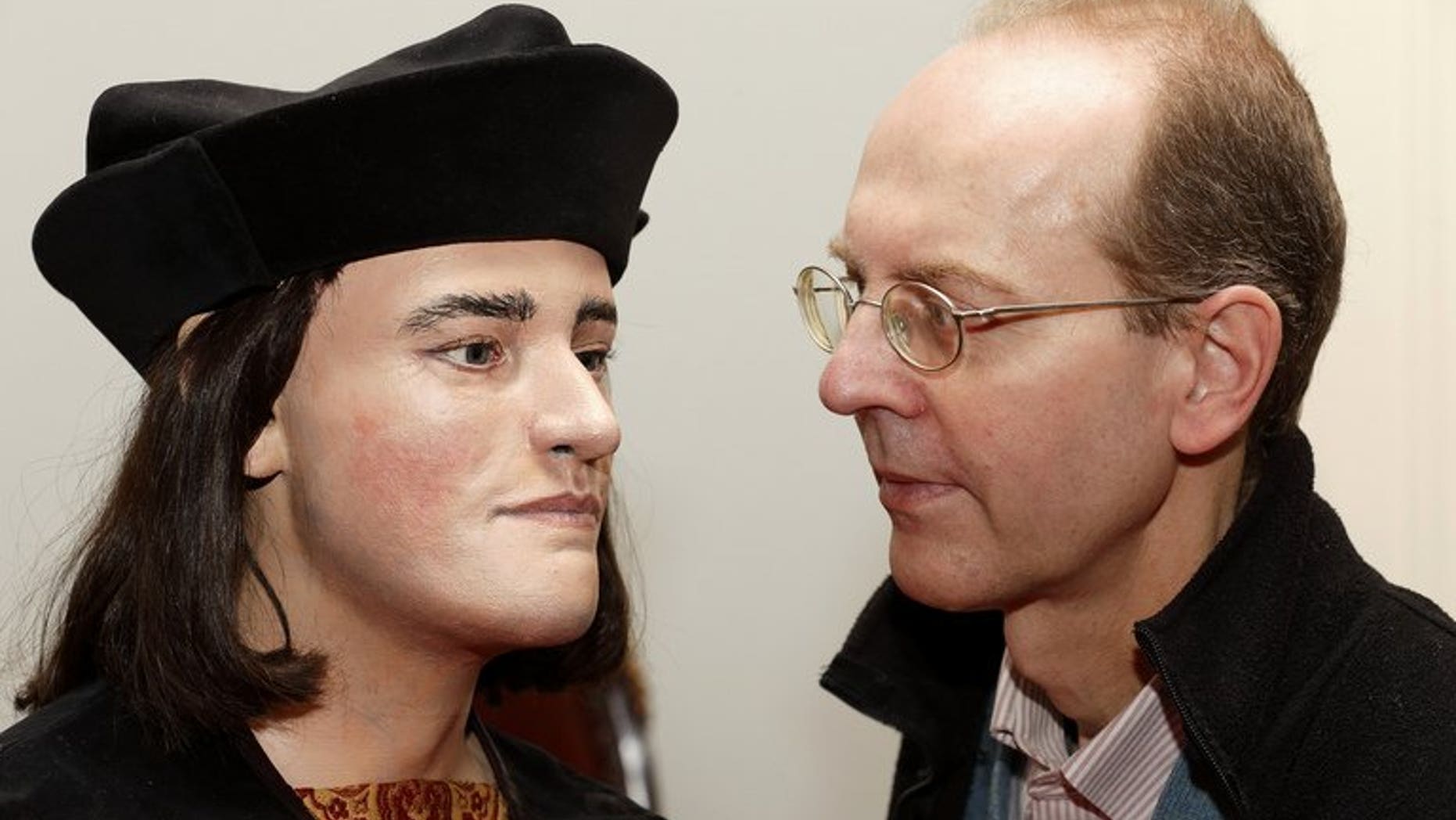 Michael Ibsen, (R) a descendant of England's King Richard III, poses for pictures with a plastic model made from the recently discovered skull of the king, in London, on February 5, 2013. The British public should be consulted on the final resting place of the 15th-century king whose skeleton was found under a car park, a judge ruled on Friday.