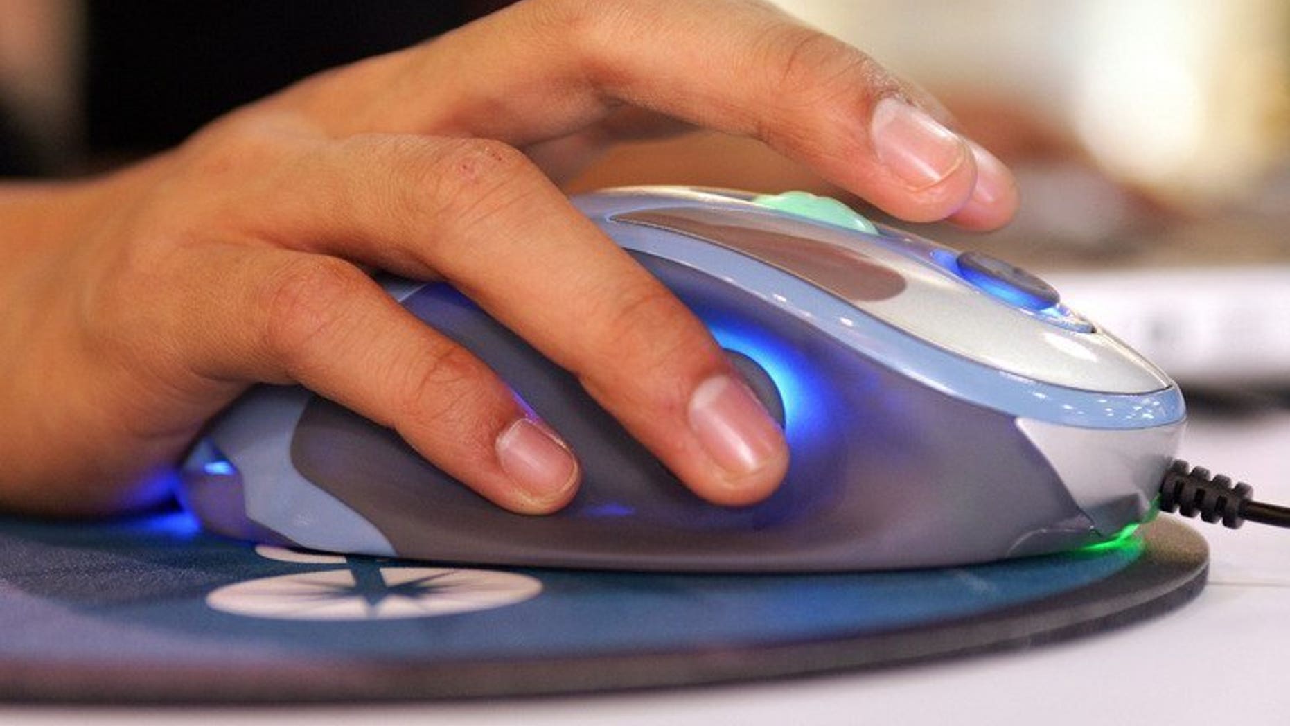 An exhibitor uses a mouse at the Consumer Electronics Show (CES) in Las Vegas on January 10, 2007. Police said on Friday they are investigating claims that a Scottish teenager killed himself because he was being blackmailed online.