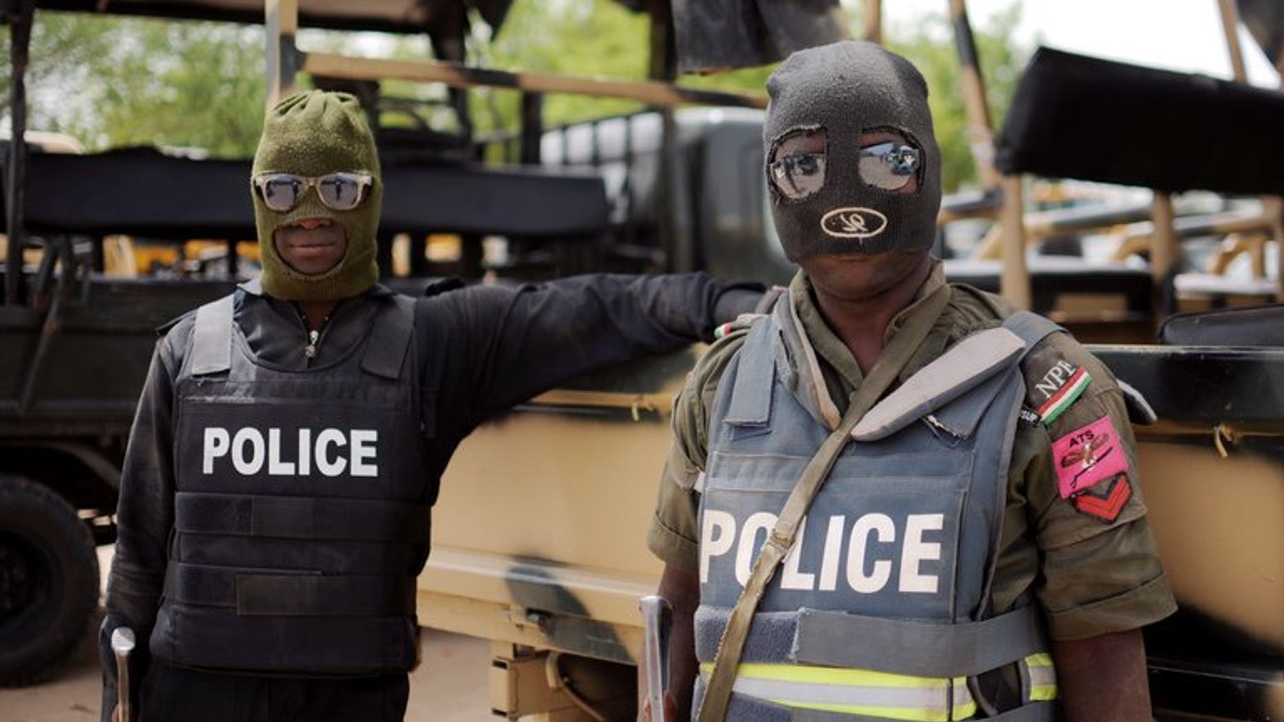 Nigerian police, part of the joint forces in Borno state, pose prior to a patrol in Maiduguri on June 5, 2013. Suspected Boko Haram Islamists have stormed a town in northeast Nigeria, opened fire on police and civilians and killed 11 people, residents and a local lawmaker told AFP Friday.