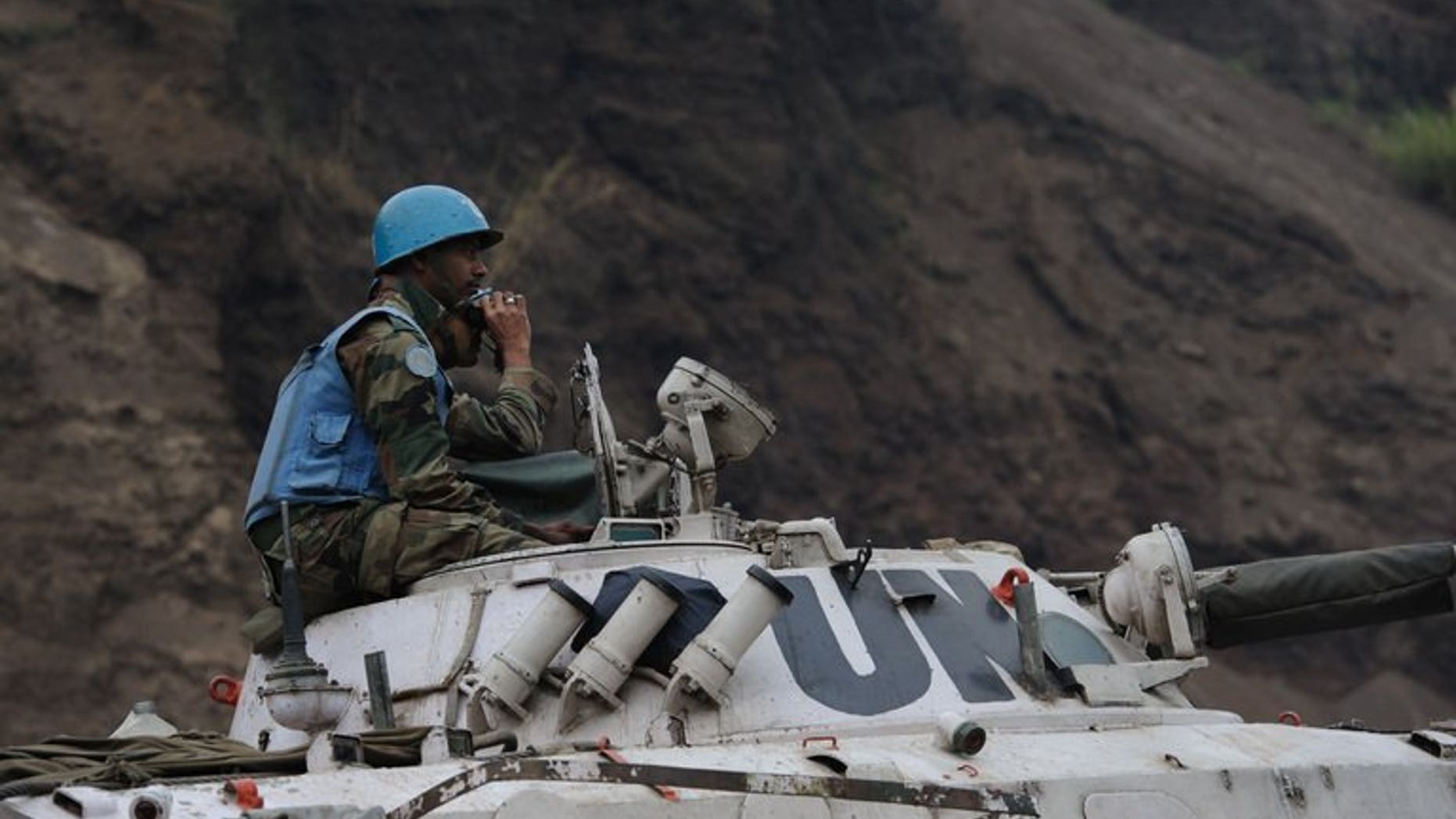Peacekeepers operating as part of the United Nations Stabilisation Mission for the Congo (MONUSCO) wait in Munigi on July 19, 2013. More than 80 children, some as young as eight years old, have been rescued from an armed group in the southeastern Democratic Republic of Congo and are being reunited with their families, the UN said Friday.