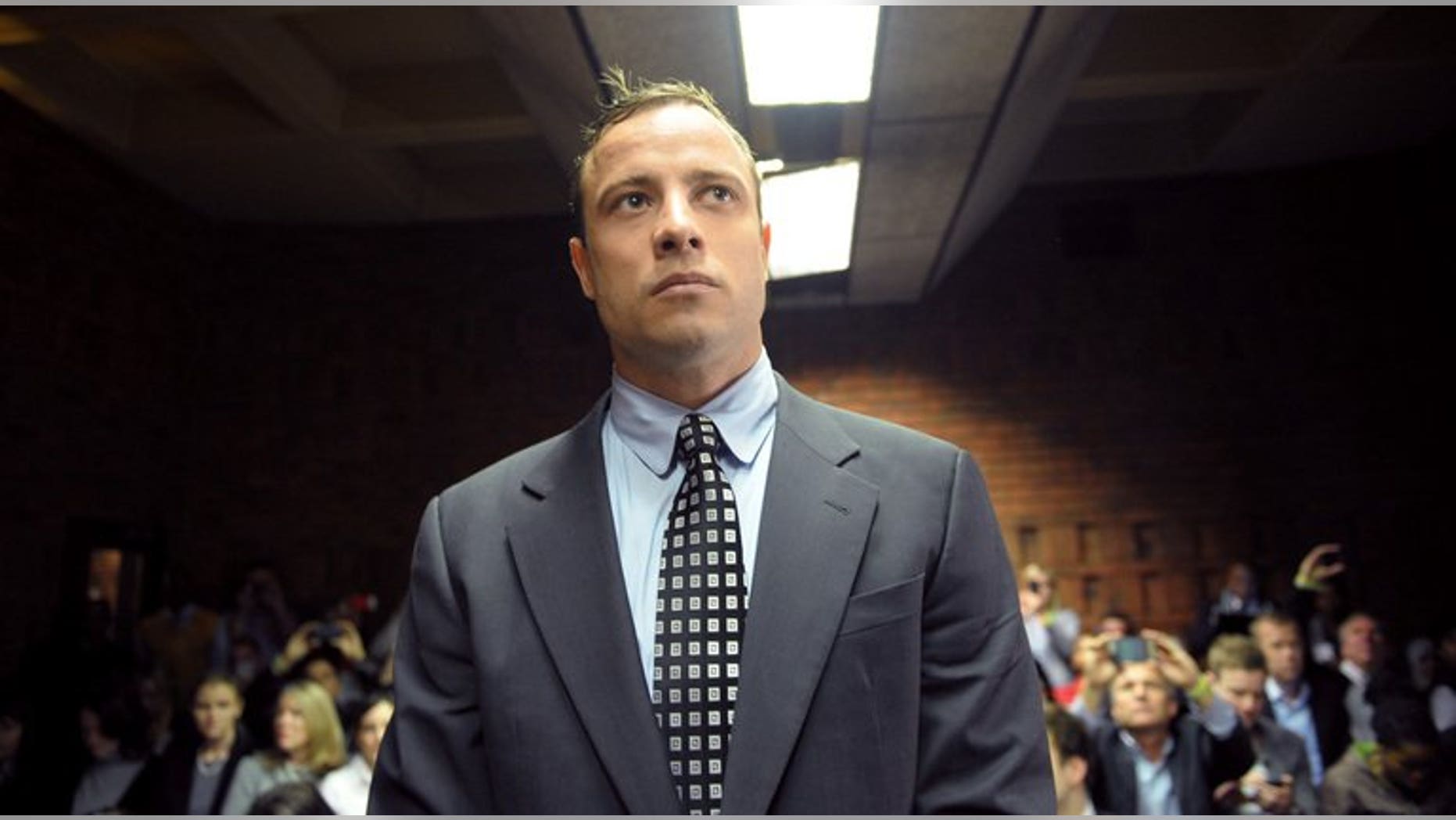 A file picture taken on June 4, 2013 shows South African Paralympic sprinter Oscar Pistorius appearing at the Magistrate Court in Pretoria. Pistorius will go on trial in March next year on murder charges for shooting his girlfriend, his lawyer said Saturday.