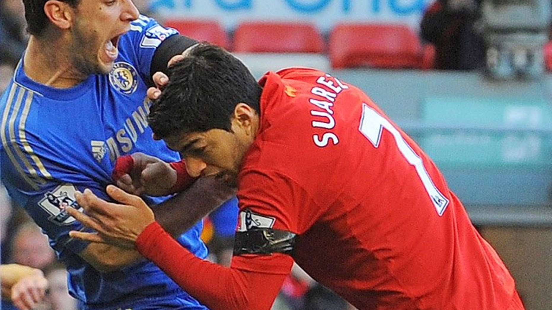 Branislav Ivanovic (left) recoils after being bitten by Luis Suarez at Anfield on April 21. Unsettled Liverpool striker Luis Suarez made his return to Anfield on Saturday, saluting fans from beside the pitch prior to his side's opening Premier League game against Stoke City.