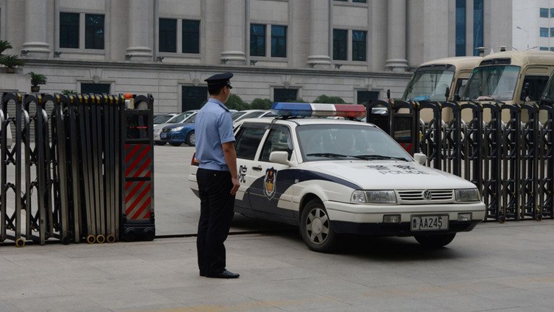 Police leave the Intermediate People's Court in Jinan, Shandong Province on July 25, 2013. Chinese police have detained a prominent human rights activist, signalling the continuation of a recent crackdown on dissent, an advocacy group said on Saturday.